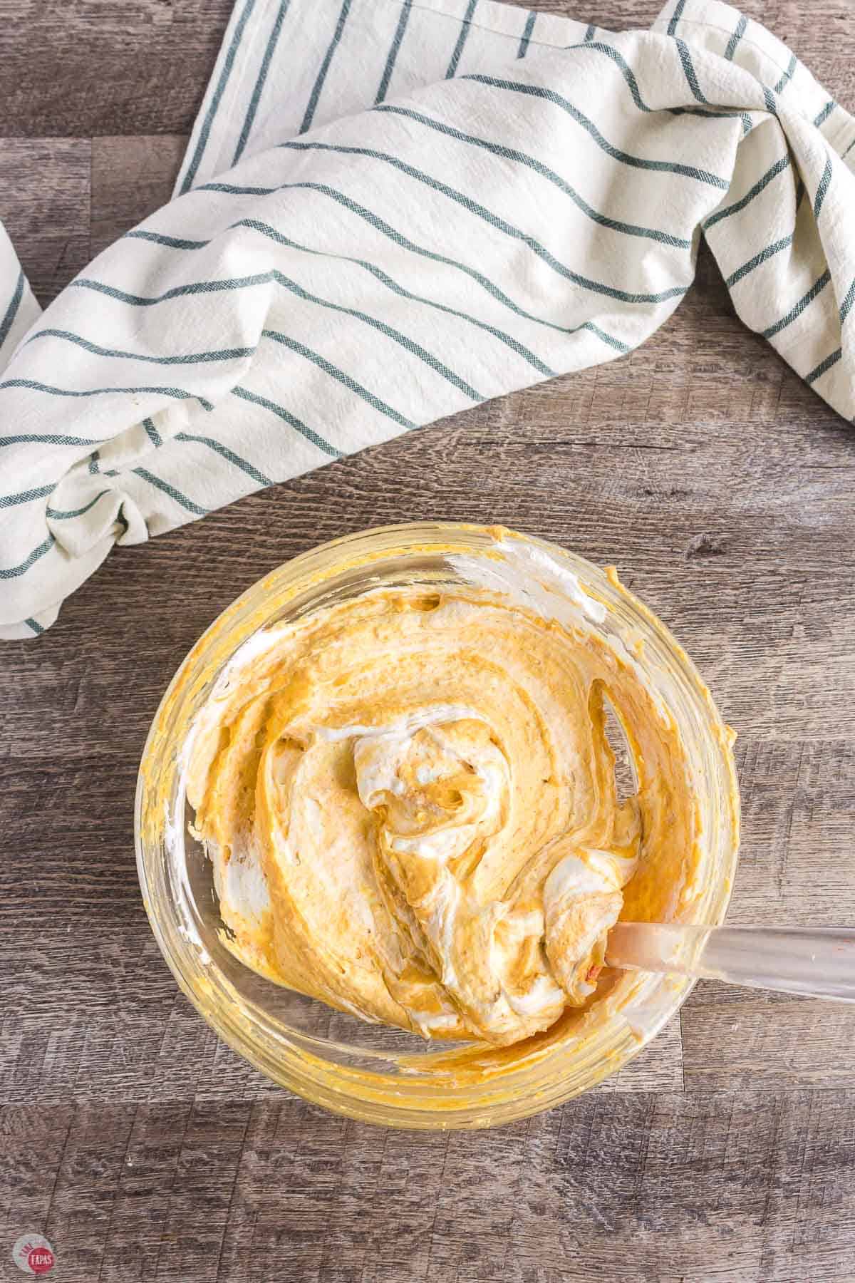 pumpkin dip being mixed in a bowl