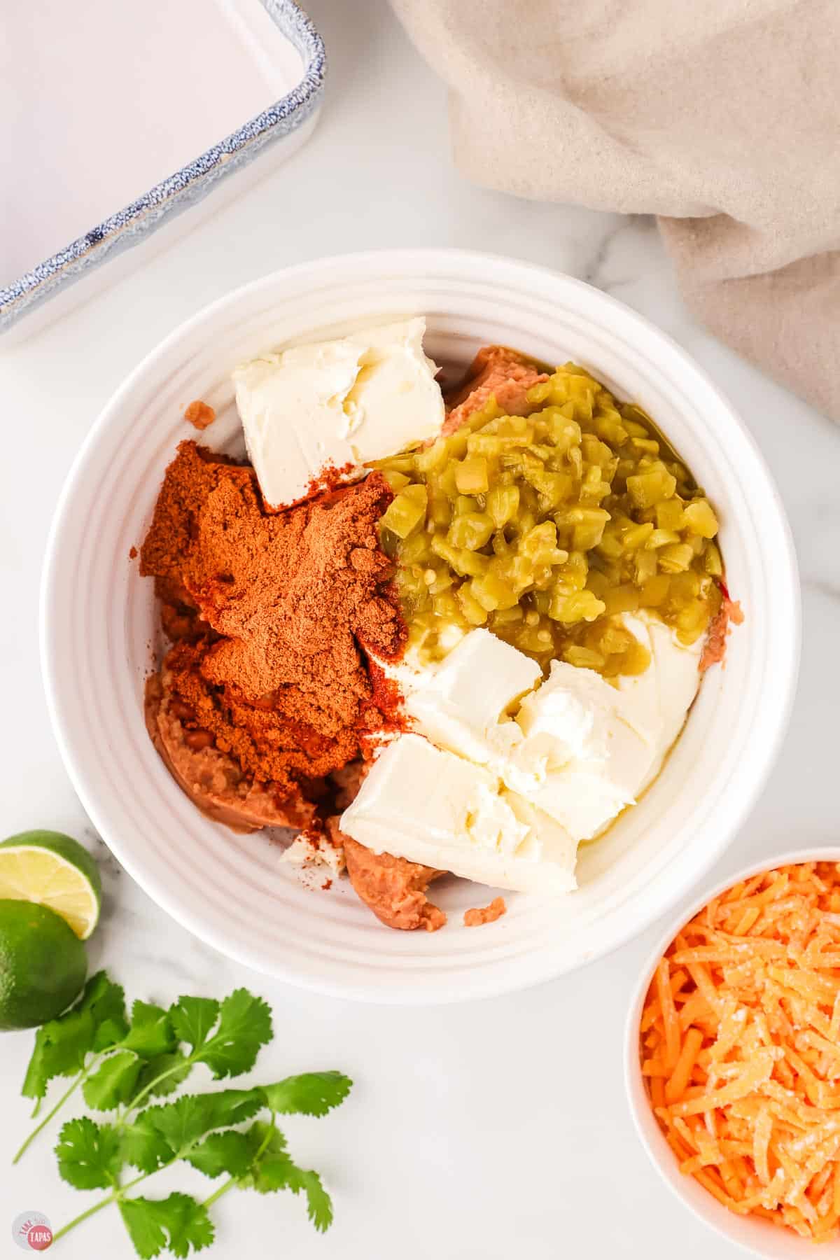 cream cheese, taco seasoning, and green chiles in a white bowl