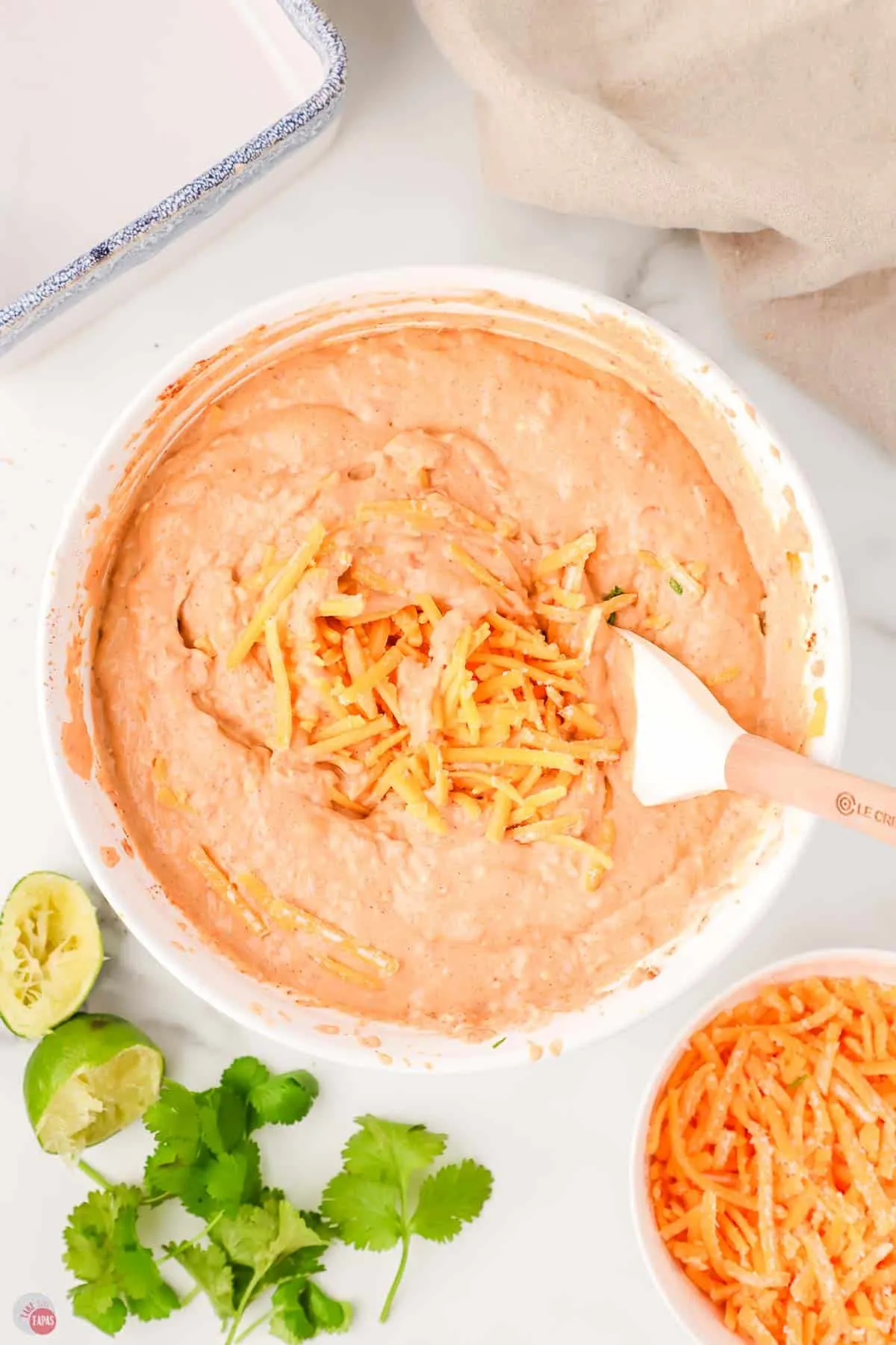 refried bean dip in a bowl with a spatula