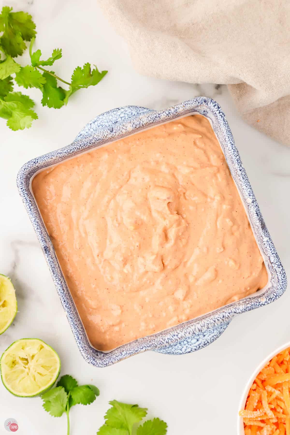 unbaked bean dip in a blue square dish