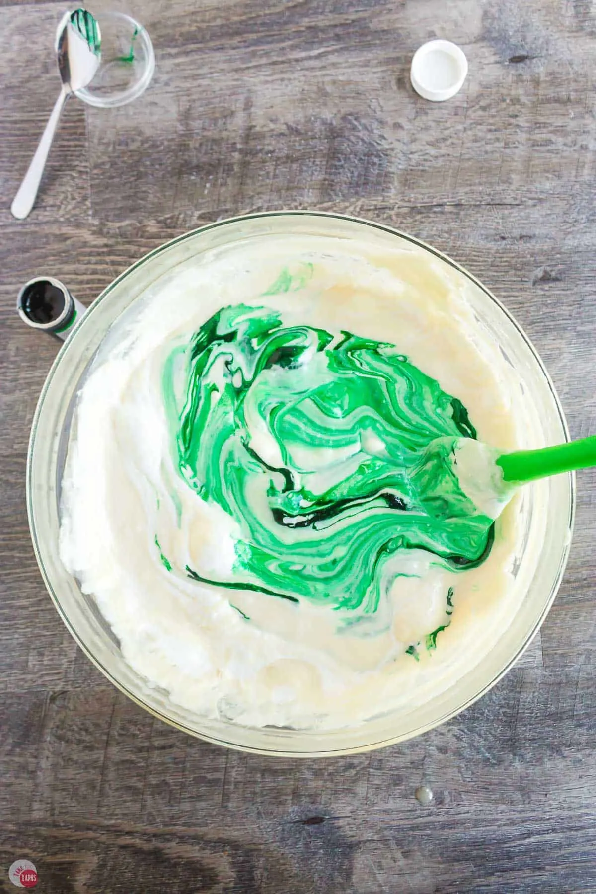 melted marshmallows with green food coloring being stirred in