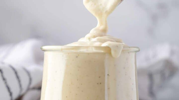 overflowing jar of sour cream sauce