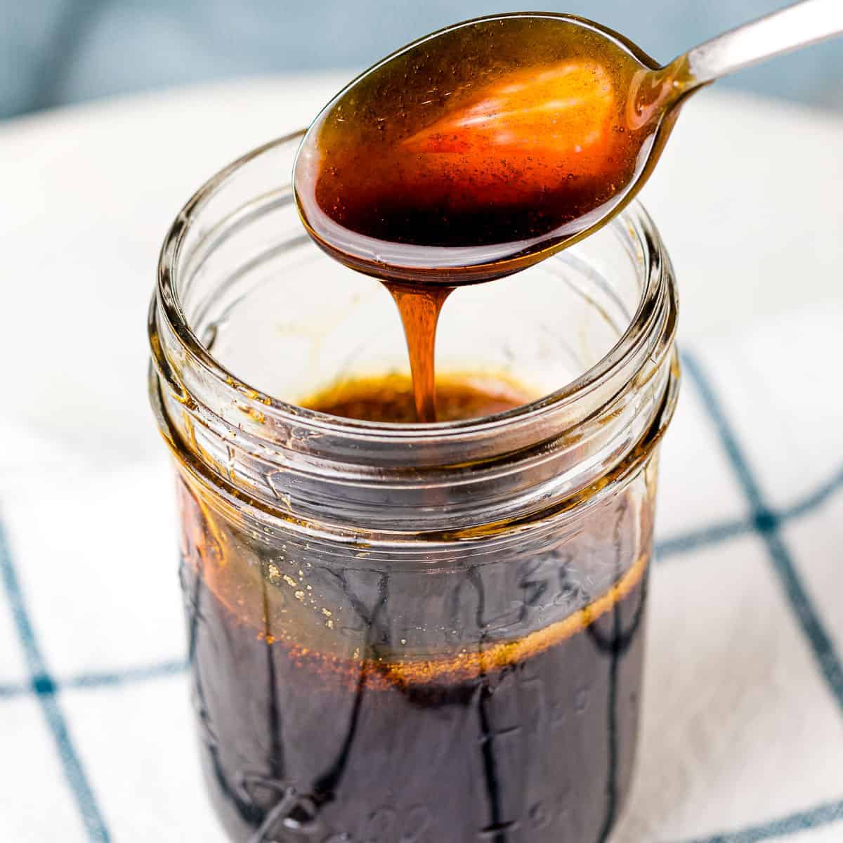 teriyaki sauce in a clear jar and a spoon