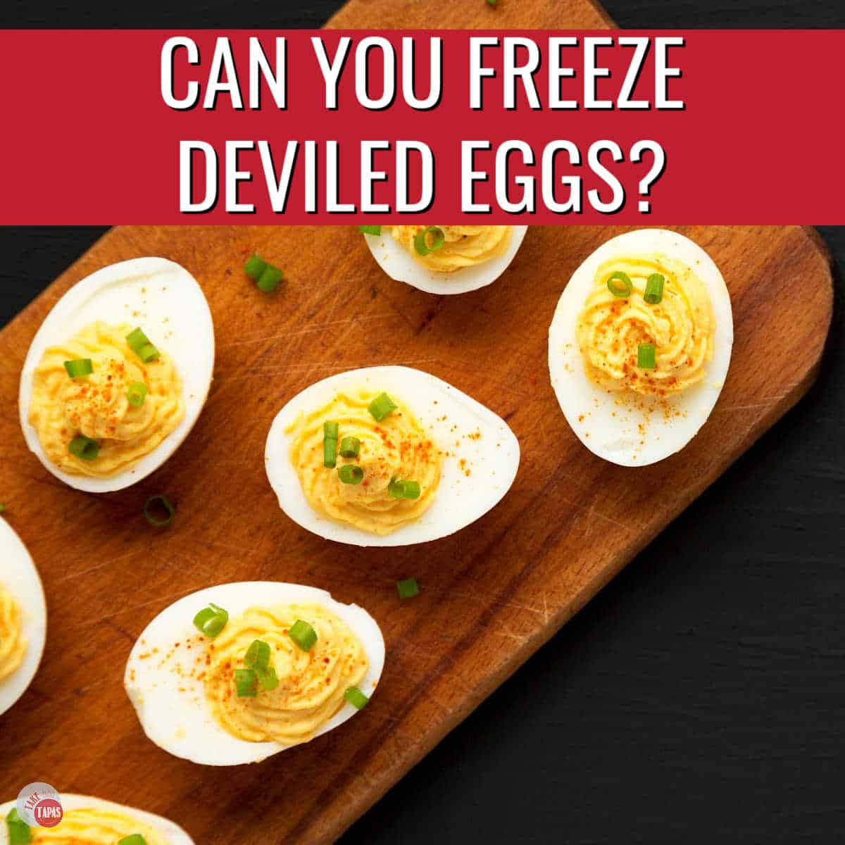 deviled eggs on a wood plank with red banner and white text