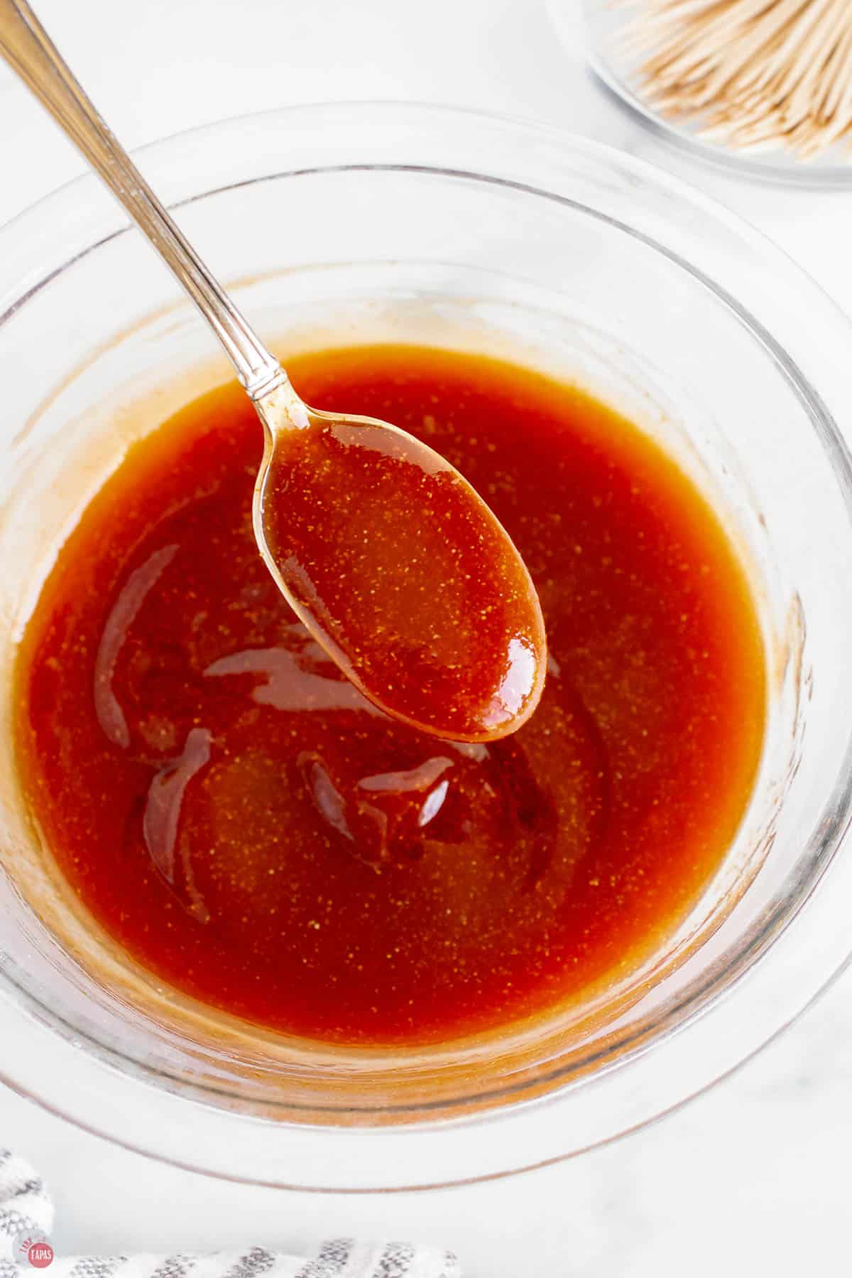 bbq sauce in a bowl with a spoon