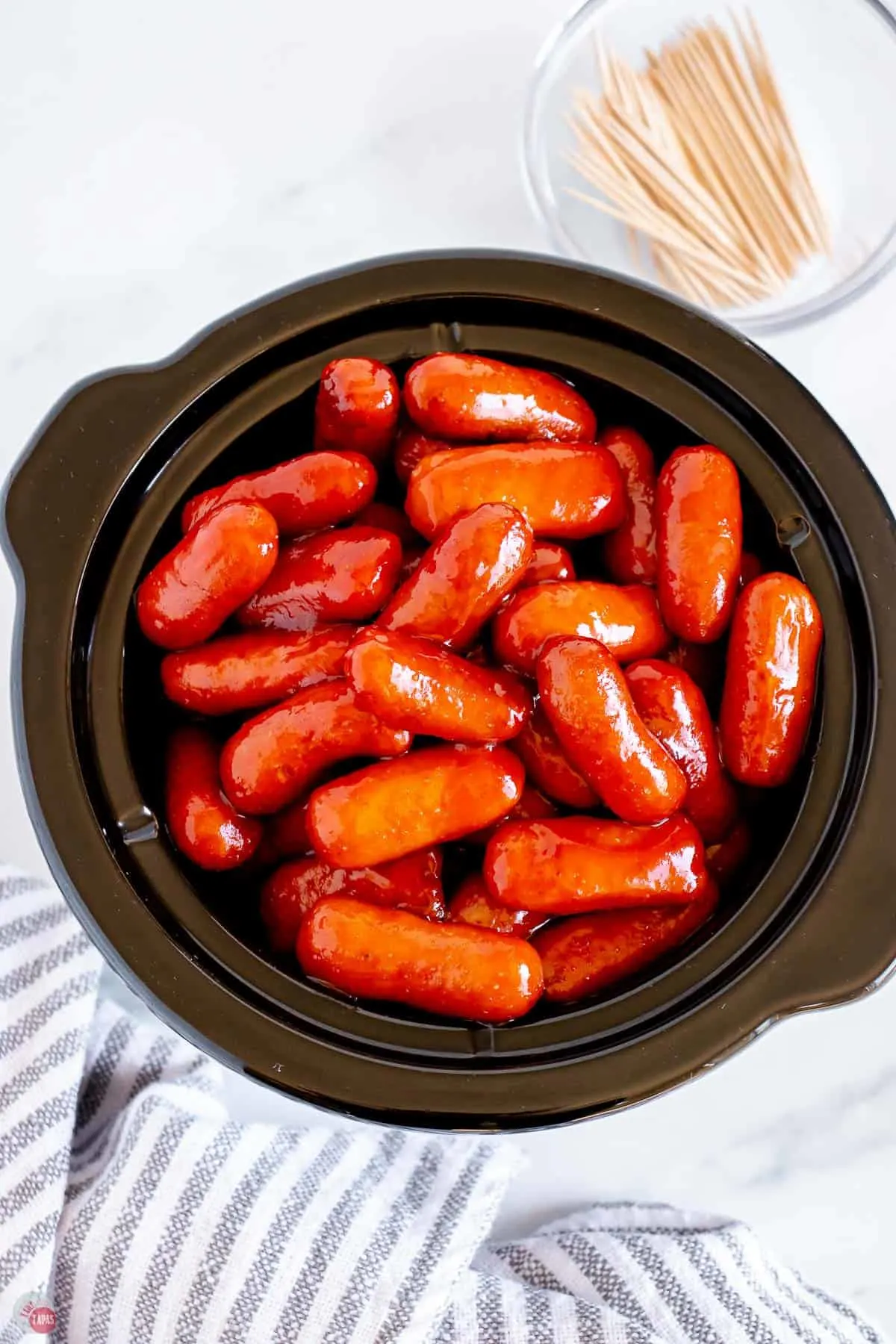 overhead picture of mini crockpot with little smokies in it