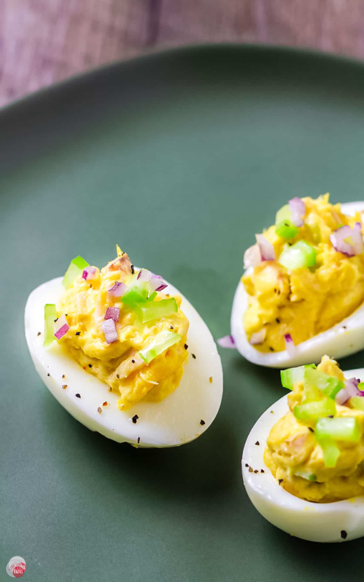 tuna salad deviled eggs on a green plate