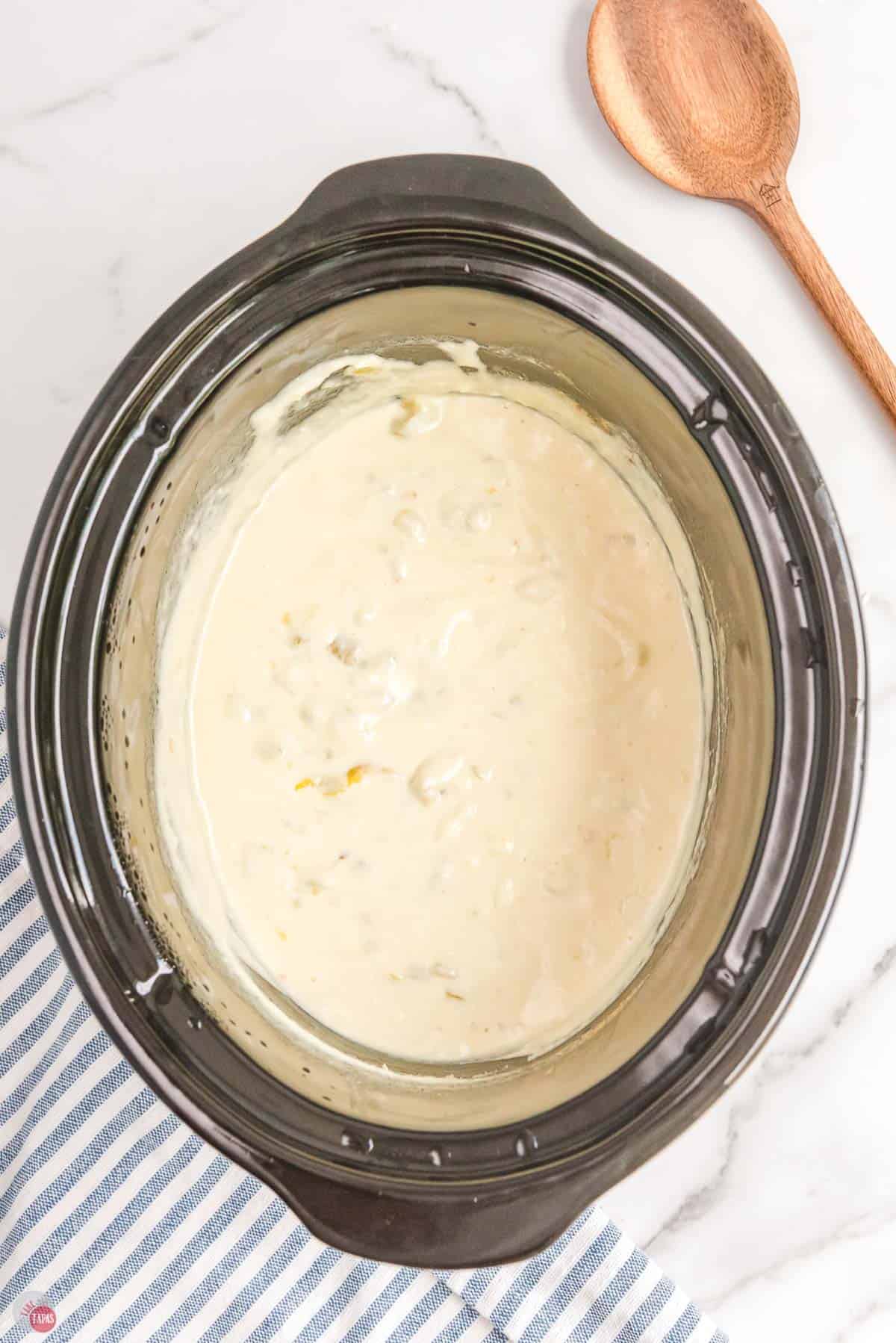 jalapeno cheese dip in a black crockpot bowl