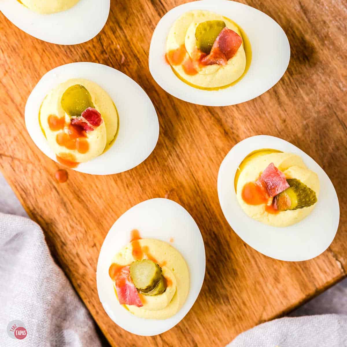 deviled eggs on a wood plank