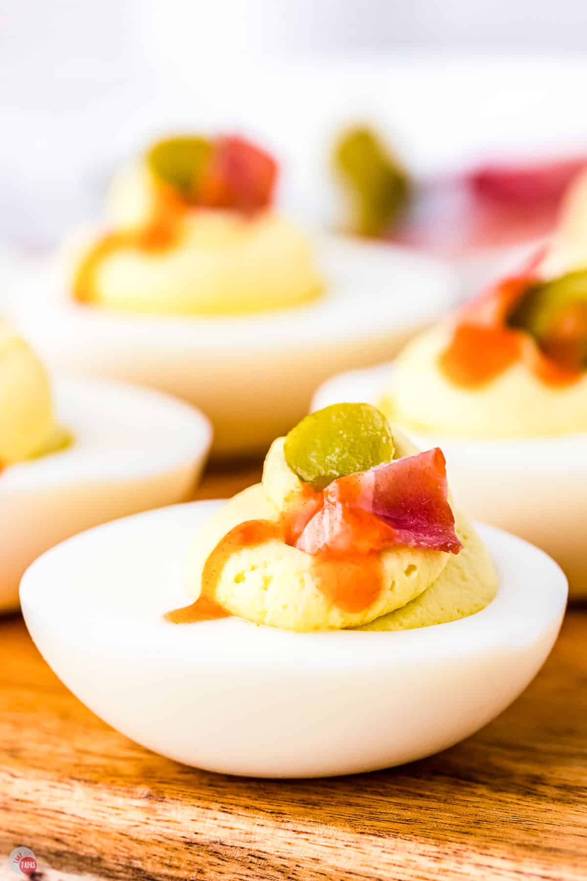deviled egg with bacon and hot sauce