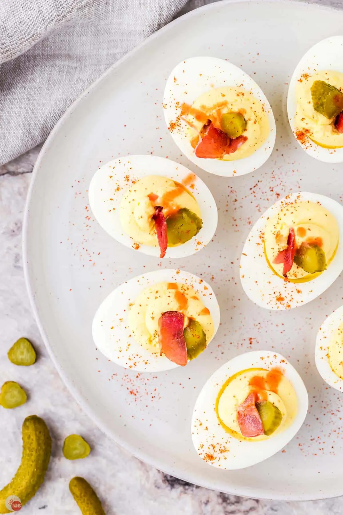 deviled eggs on a grey plate with paprika