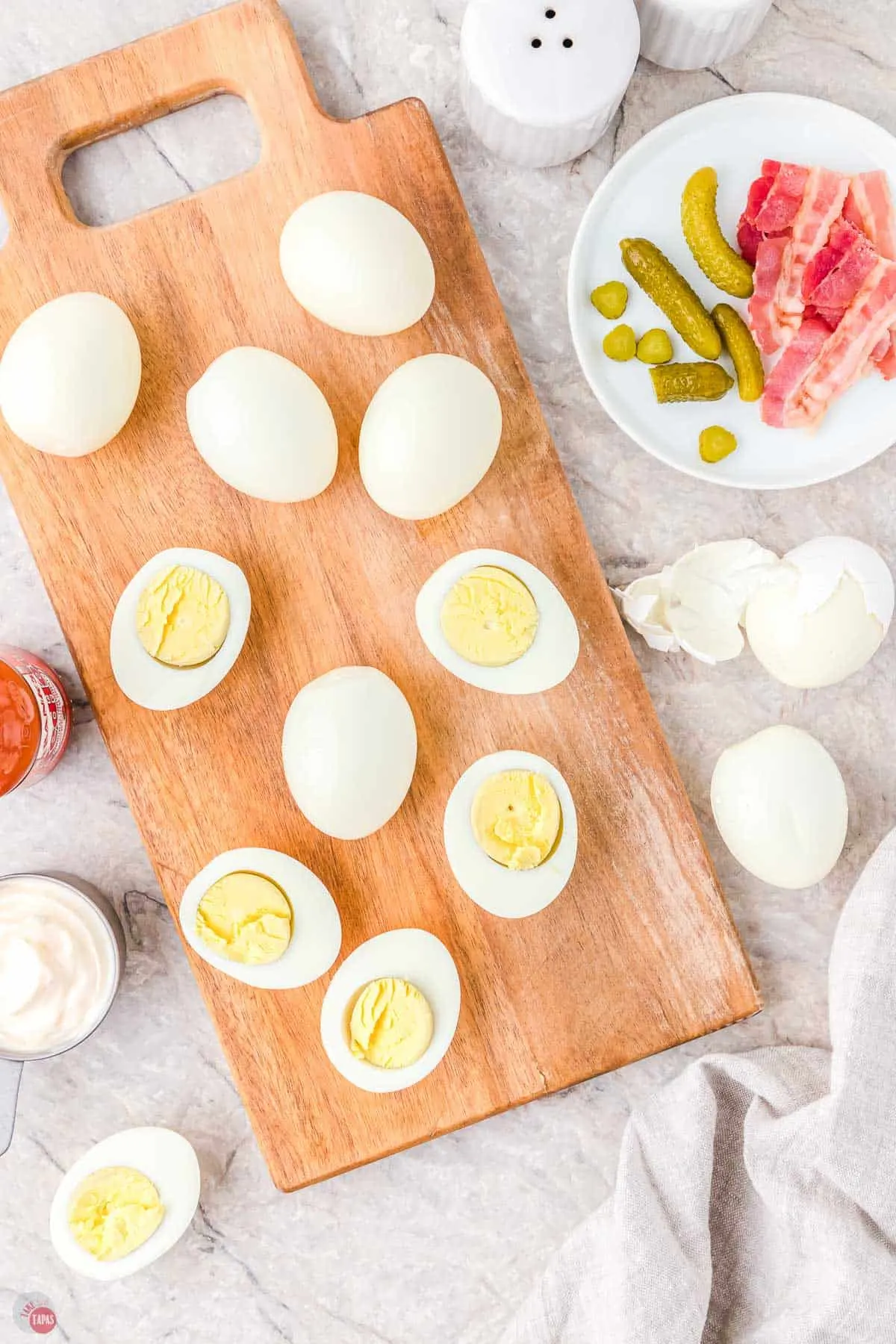 hard boiled eggs cut in half on a wood board