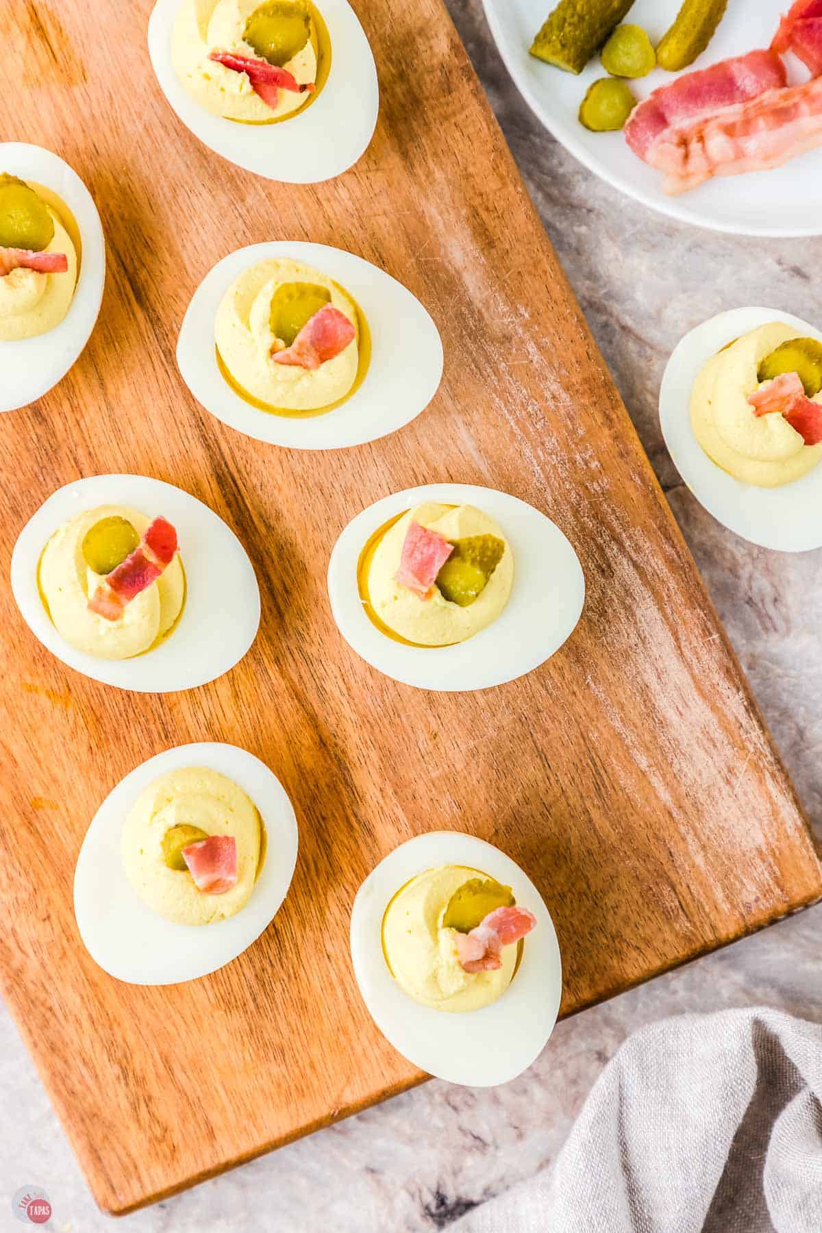 million dollar deviled eggs on a wood plank