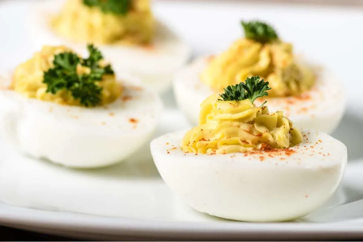 egg halves with filling, parsley, and paprika