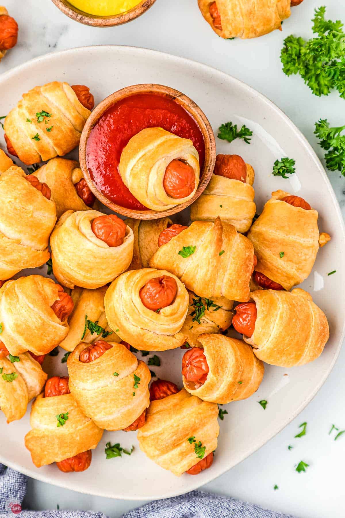 close up of air fryer pigs in a blanket with a blow of ketchup