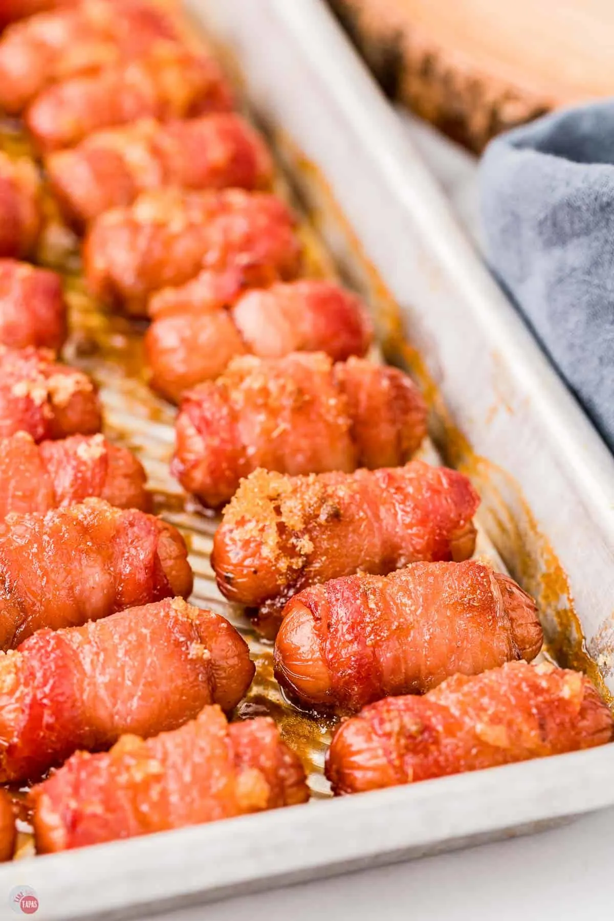 side view of pan of little sausages with bacon and crown sugar