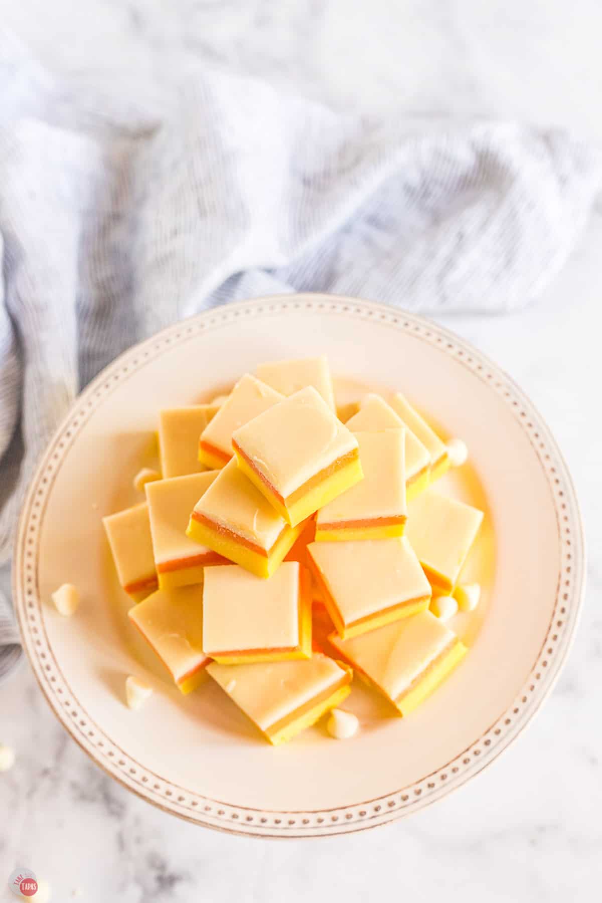 stack of candy corn fudge on a white platter