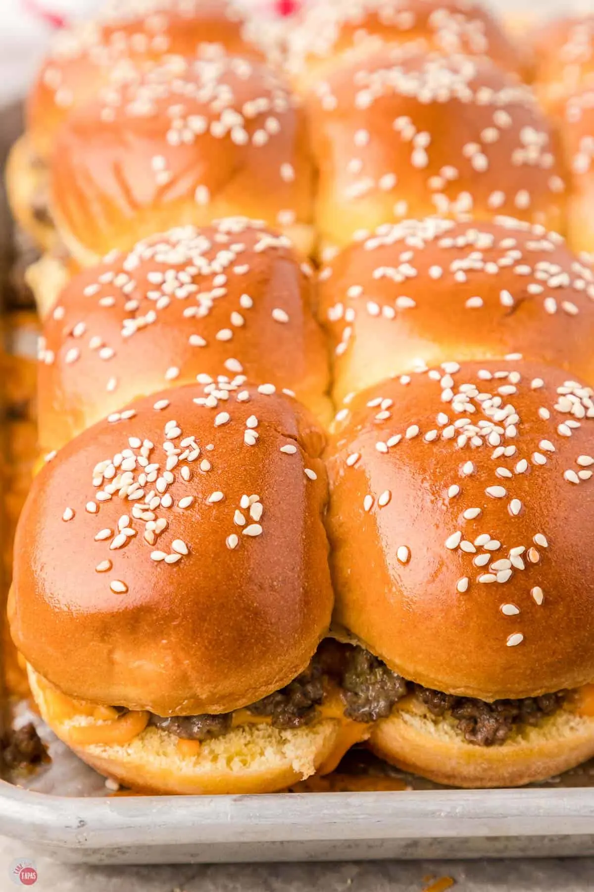 close up of sliders with sesame seeds on top
