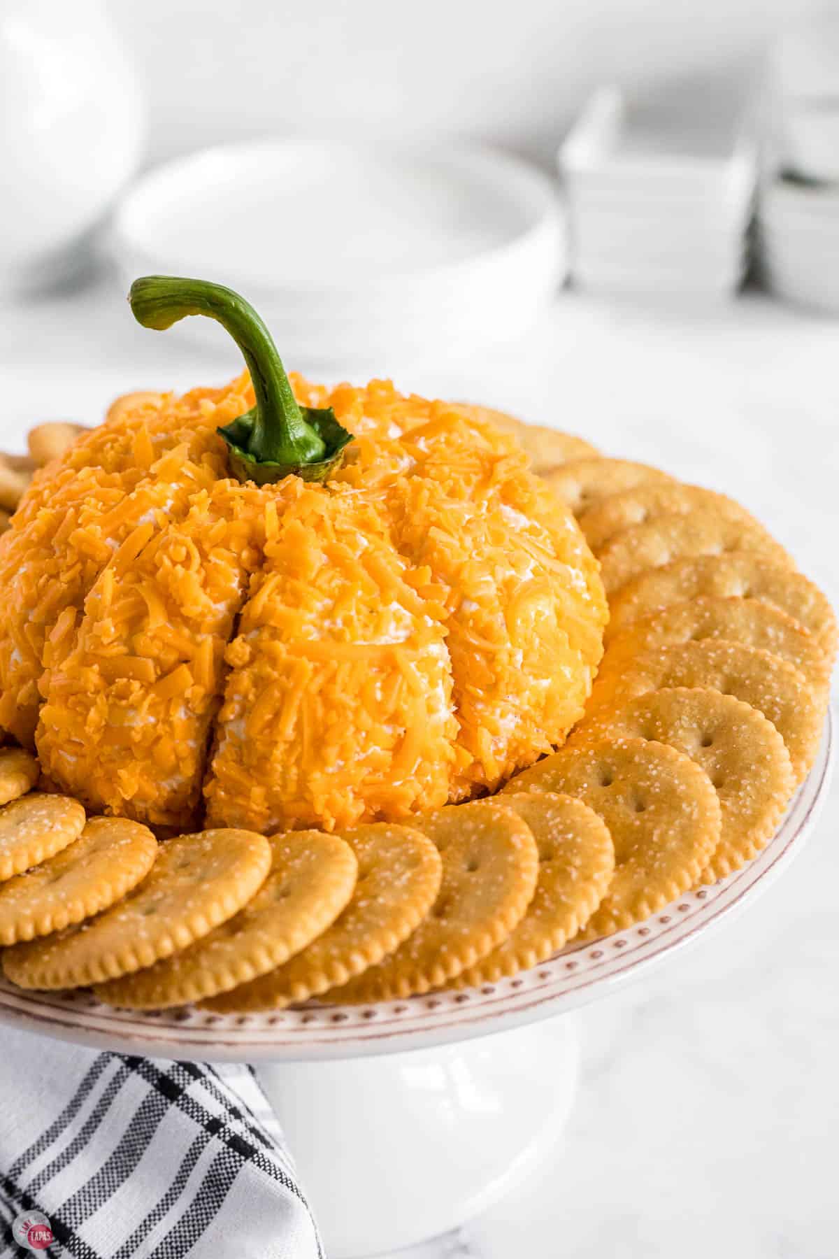 close up of pumpkin cheese ball surrounded by crackers