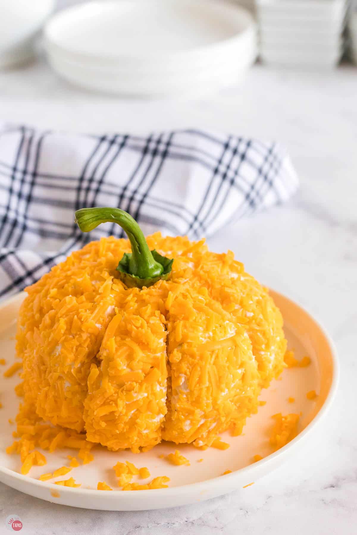 pumpkin cheese ball on a white platter