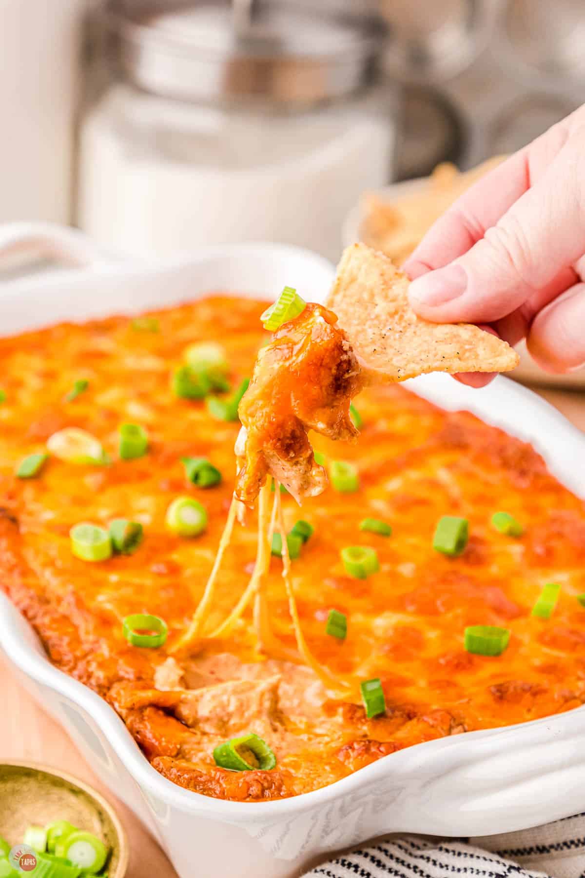 Texas Trash Dip on a chip in a hand