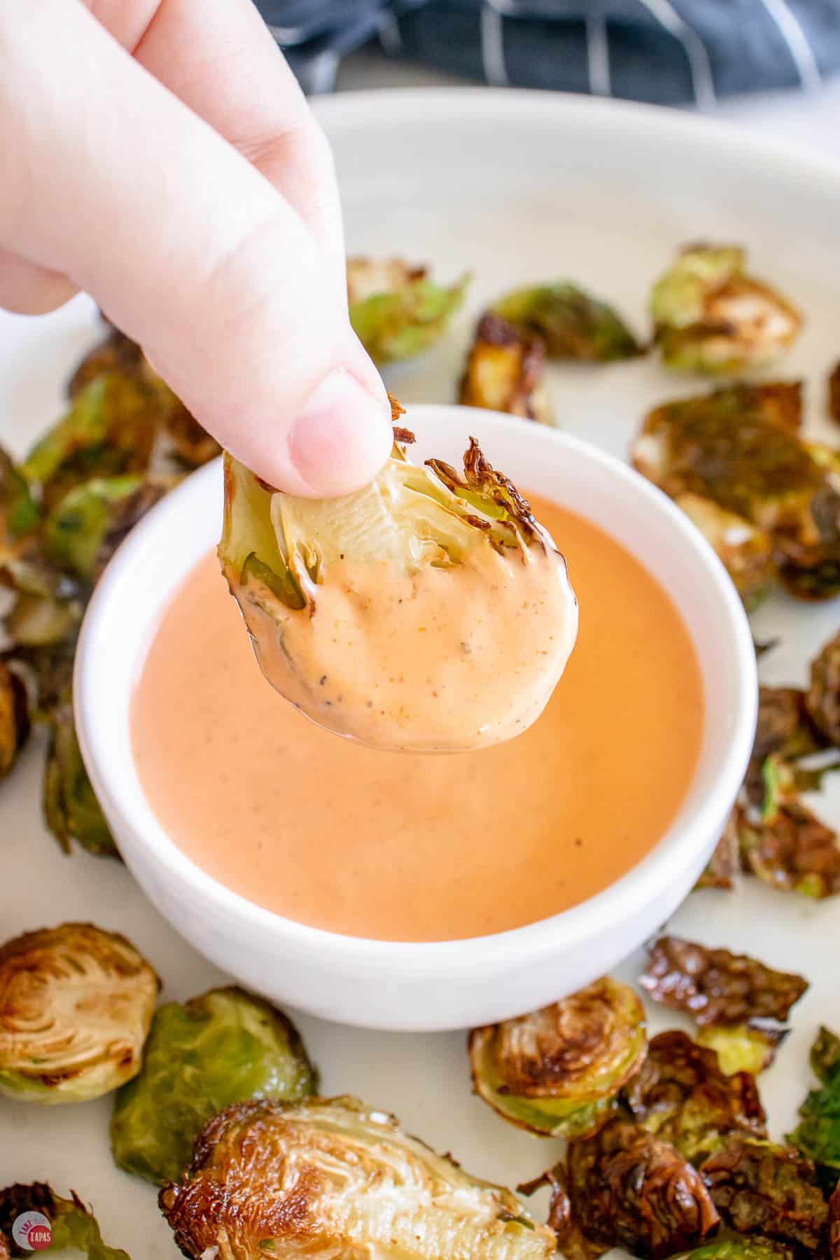 hand dipping a sprout in ranch