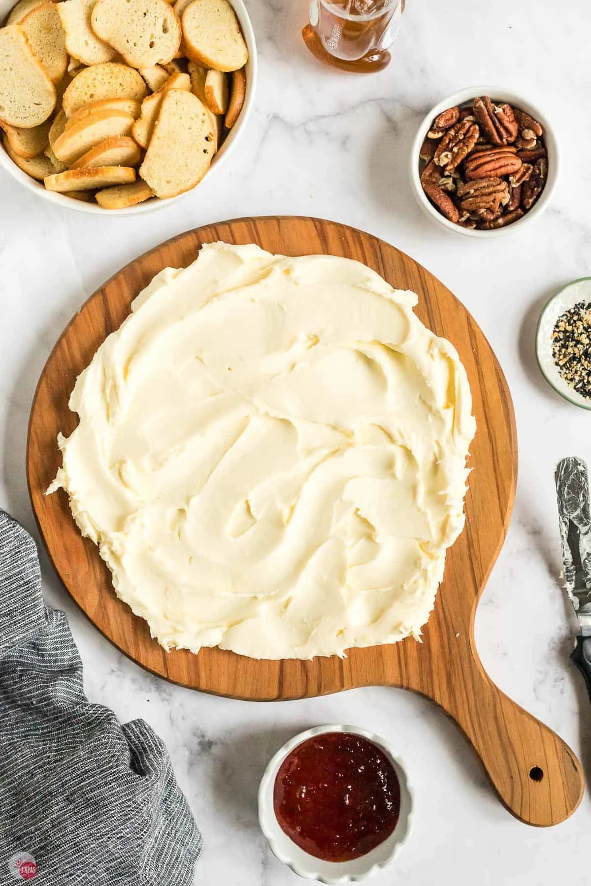 butter spread onto a round wood board