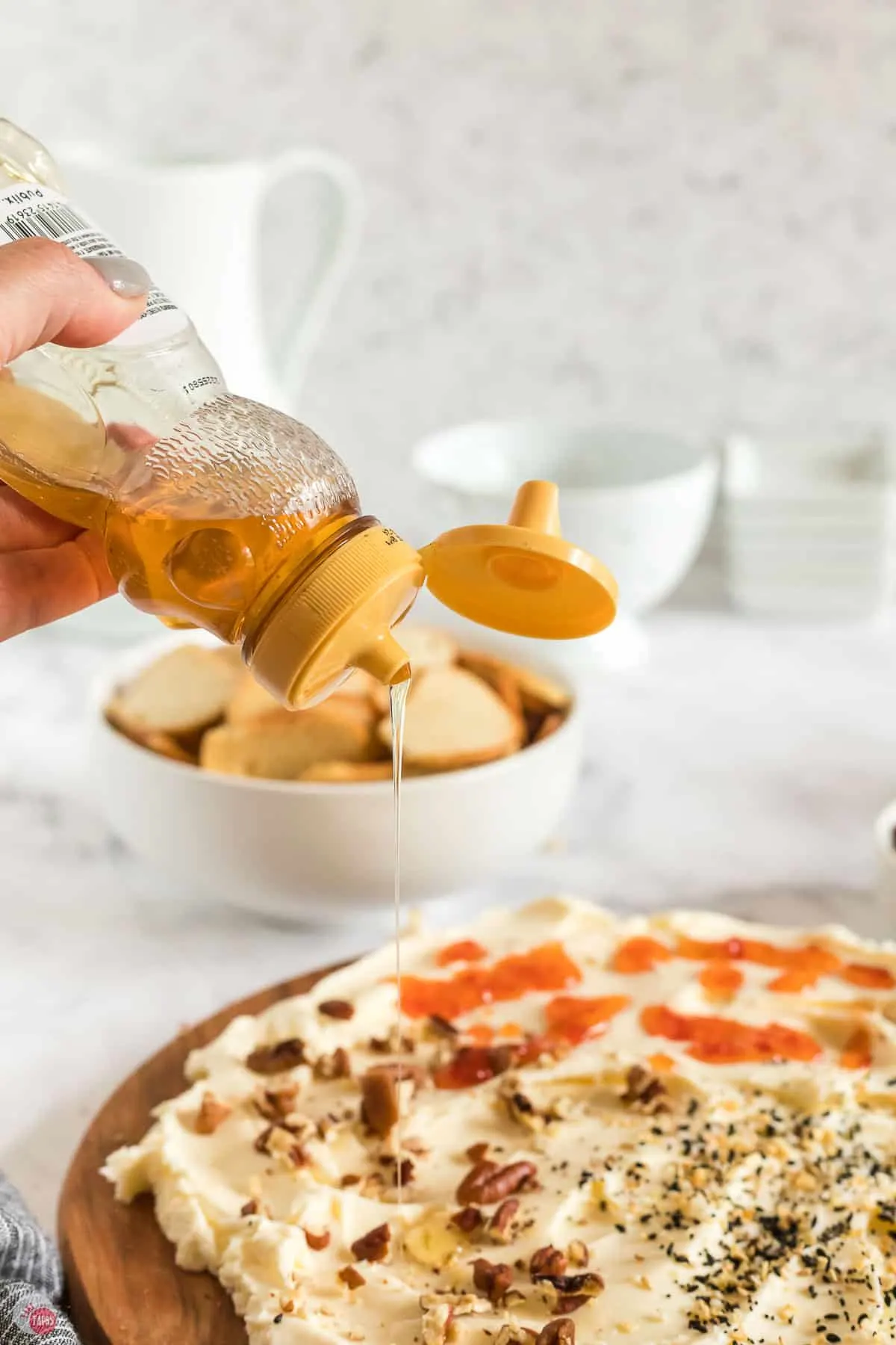 honey being drizzled on a butter board