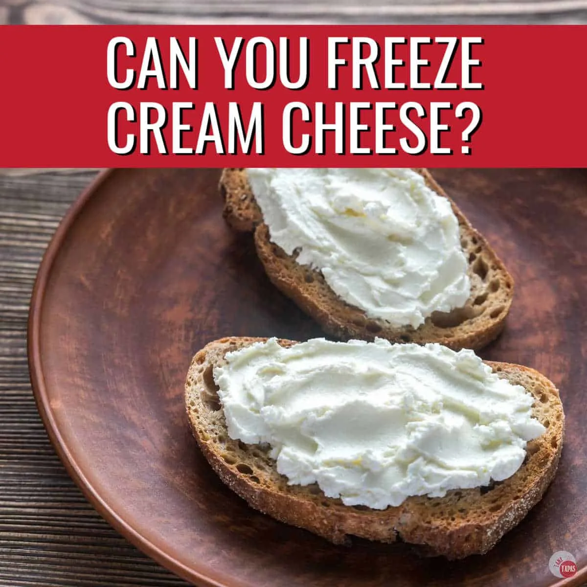 crostini with plain cream cheese smeared on and a red banner with white text