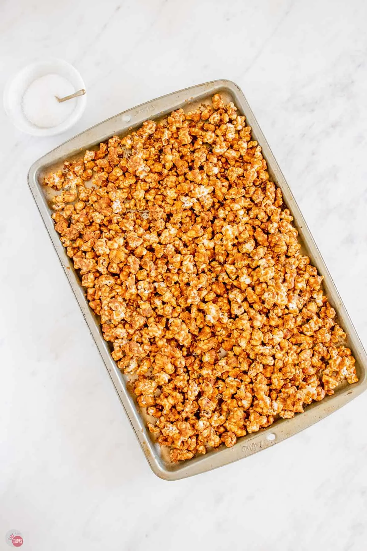 cooked popcorn on a baking sheet