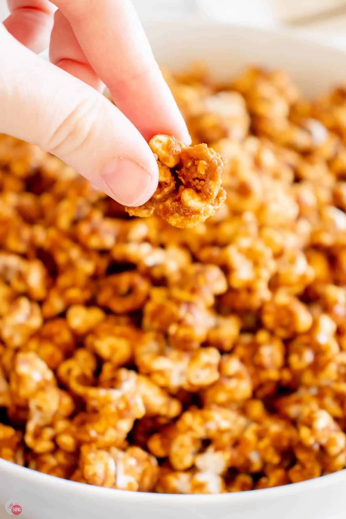 hand holding caramel popcorn