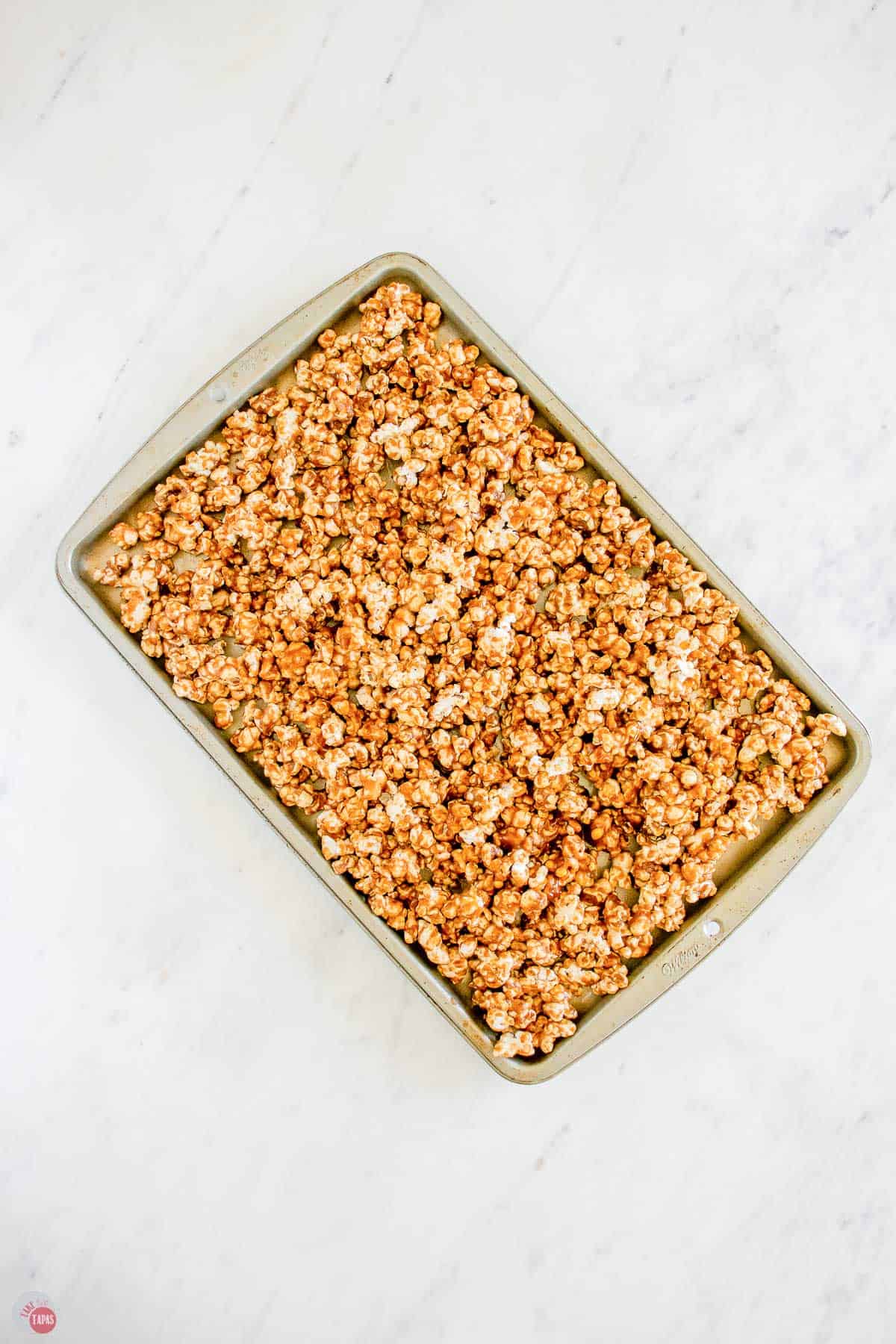 unbaked caramel corn on a baking sheet