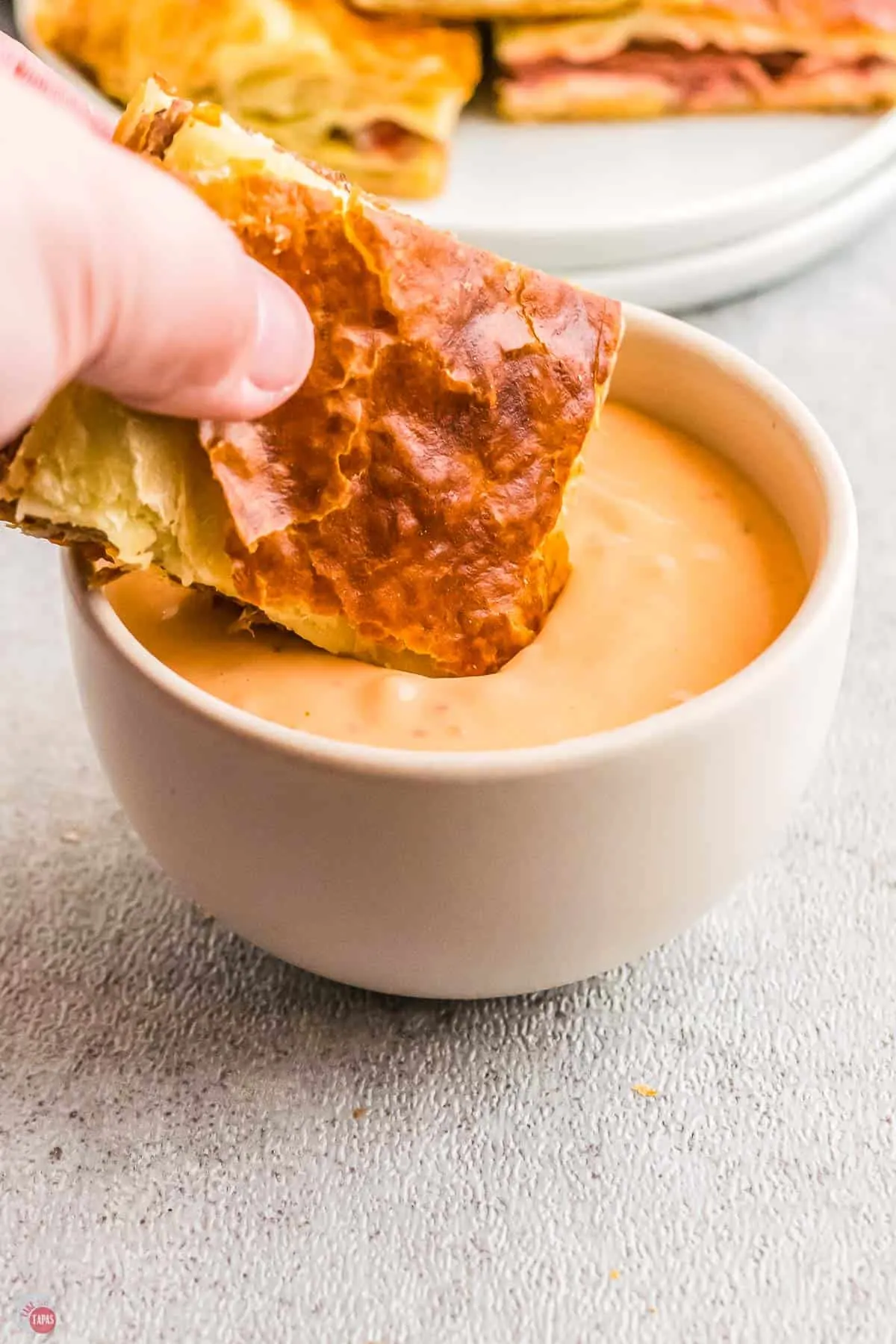 slider dipping in a bowl