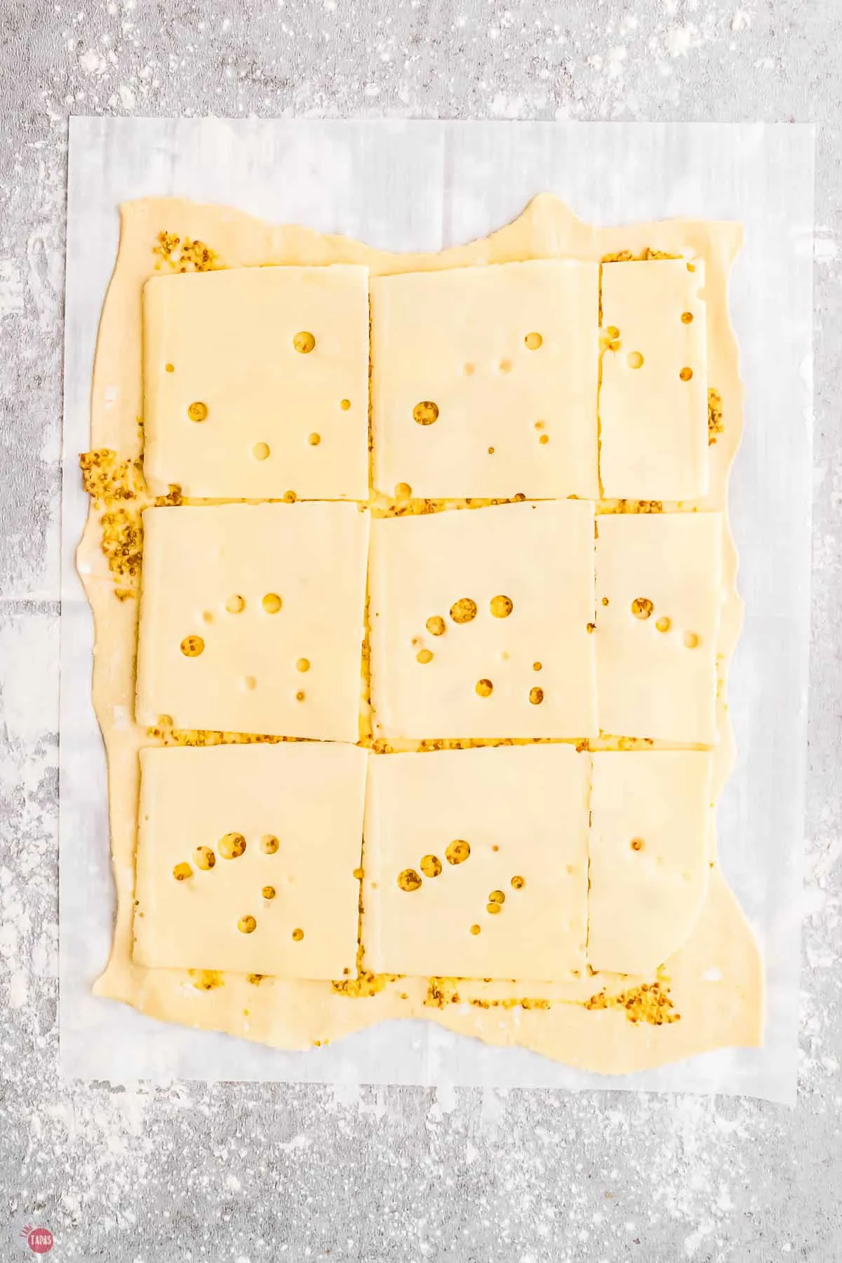 puff pastry with mustard and swiss cheese slices