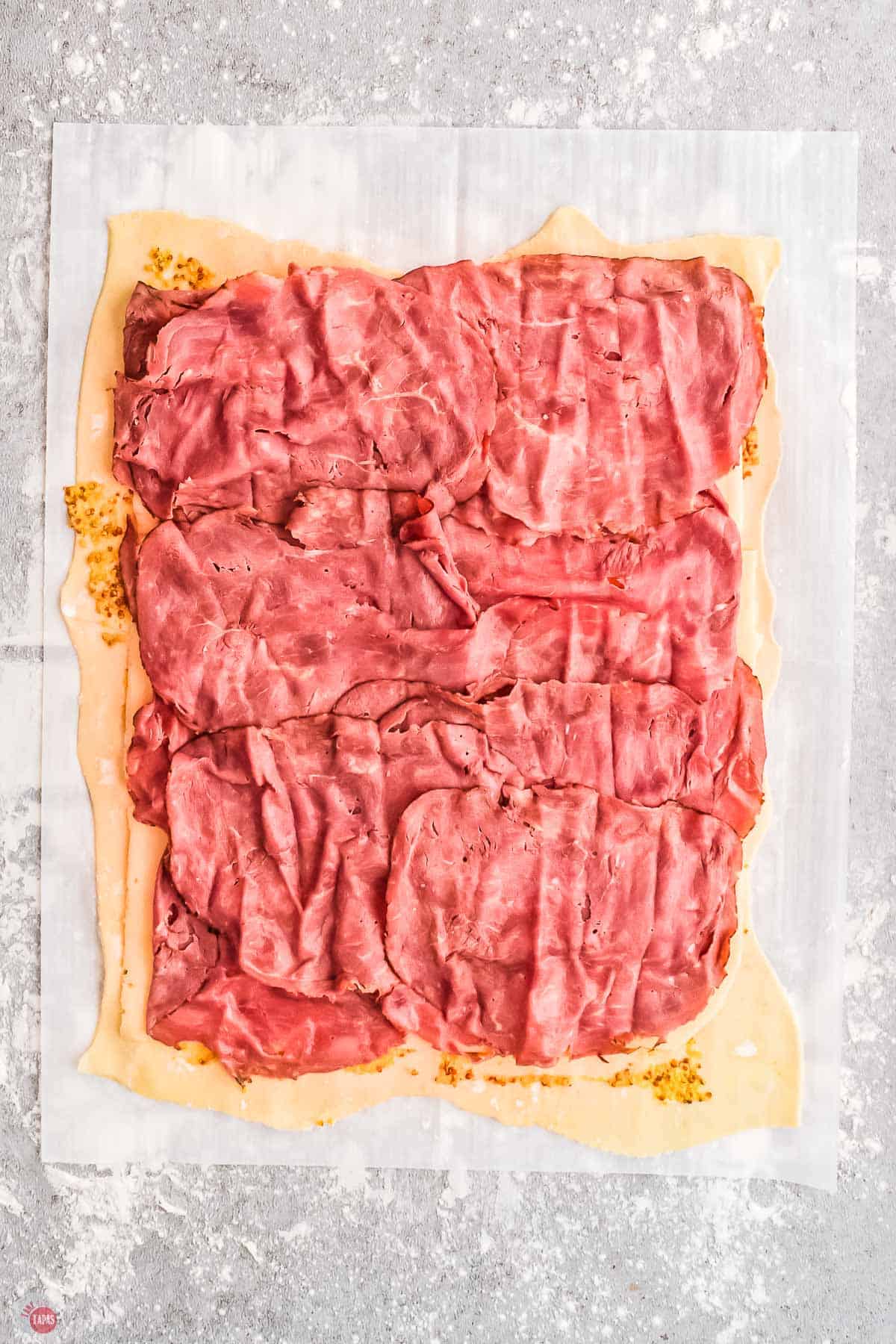 sliced corned beef on puff pastry
