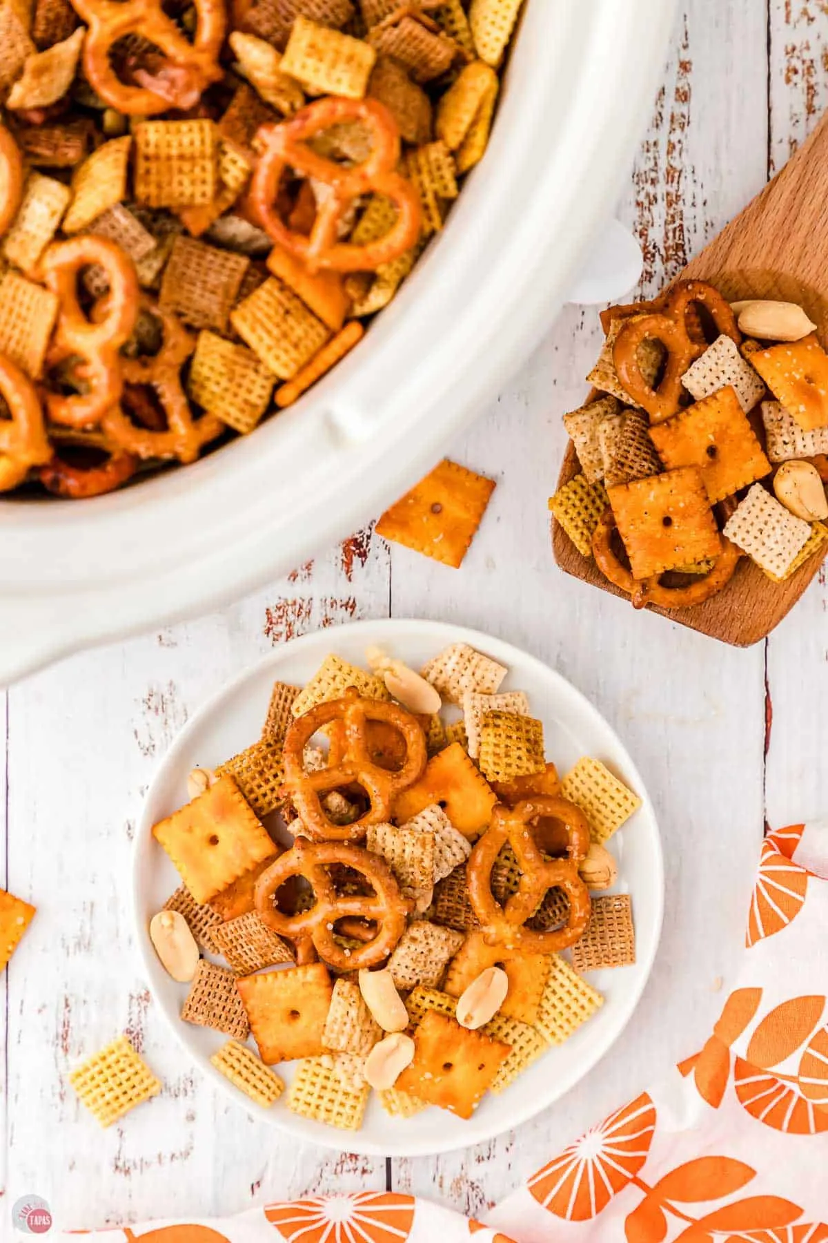 plate of snack mix next to a crock pot