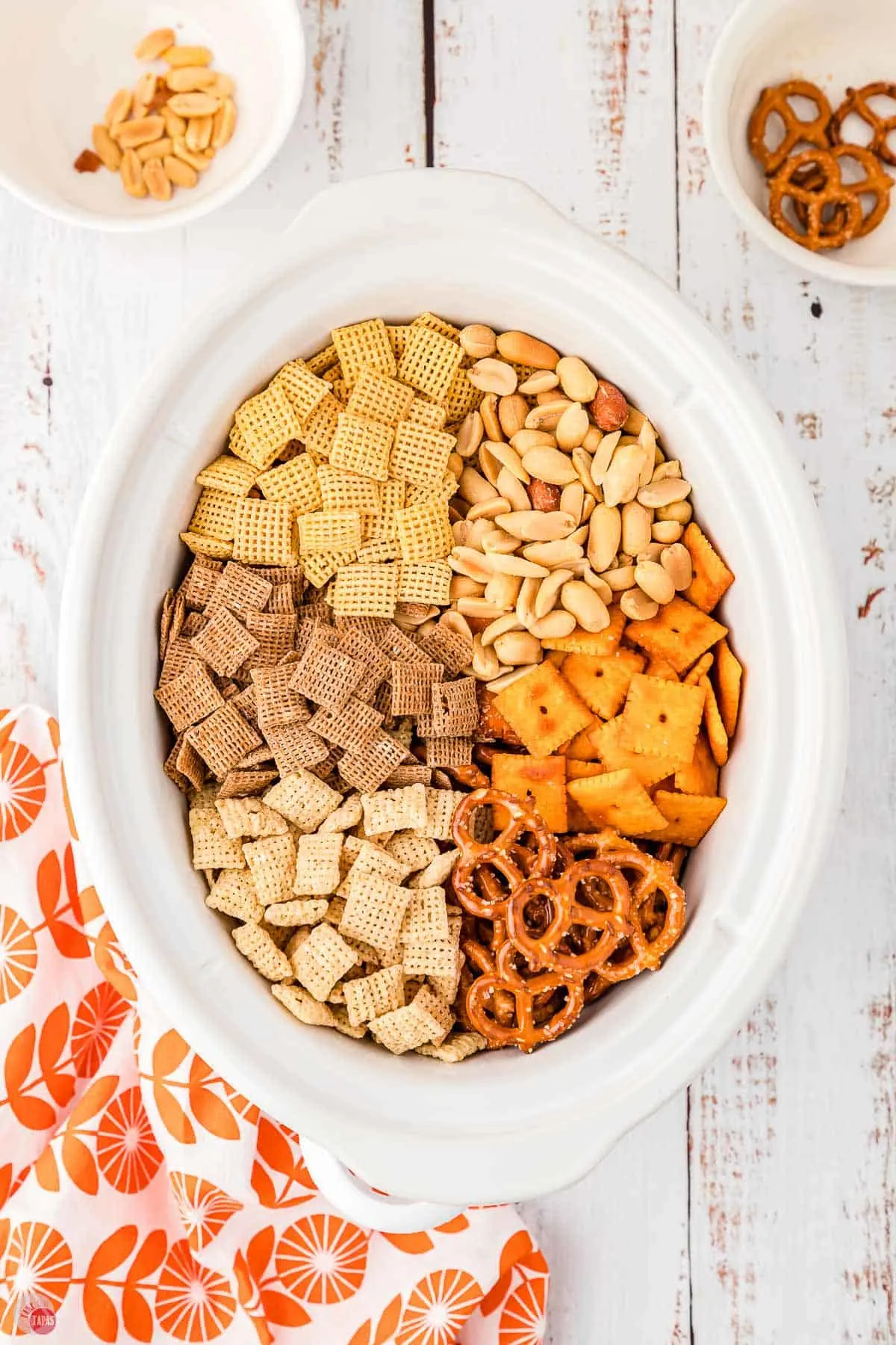 cereal and crackers in a crock pot bowl