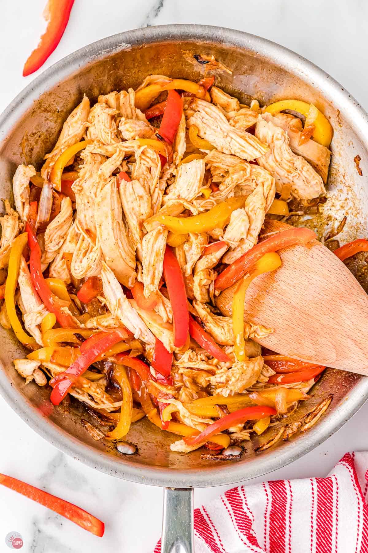 chicken, bell peppers, and onions in a skillet