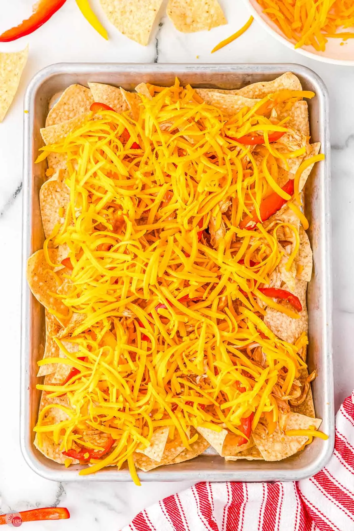shredded cheddar cheese on nacho chips