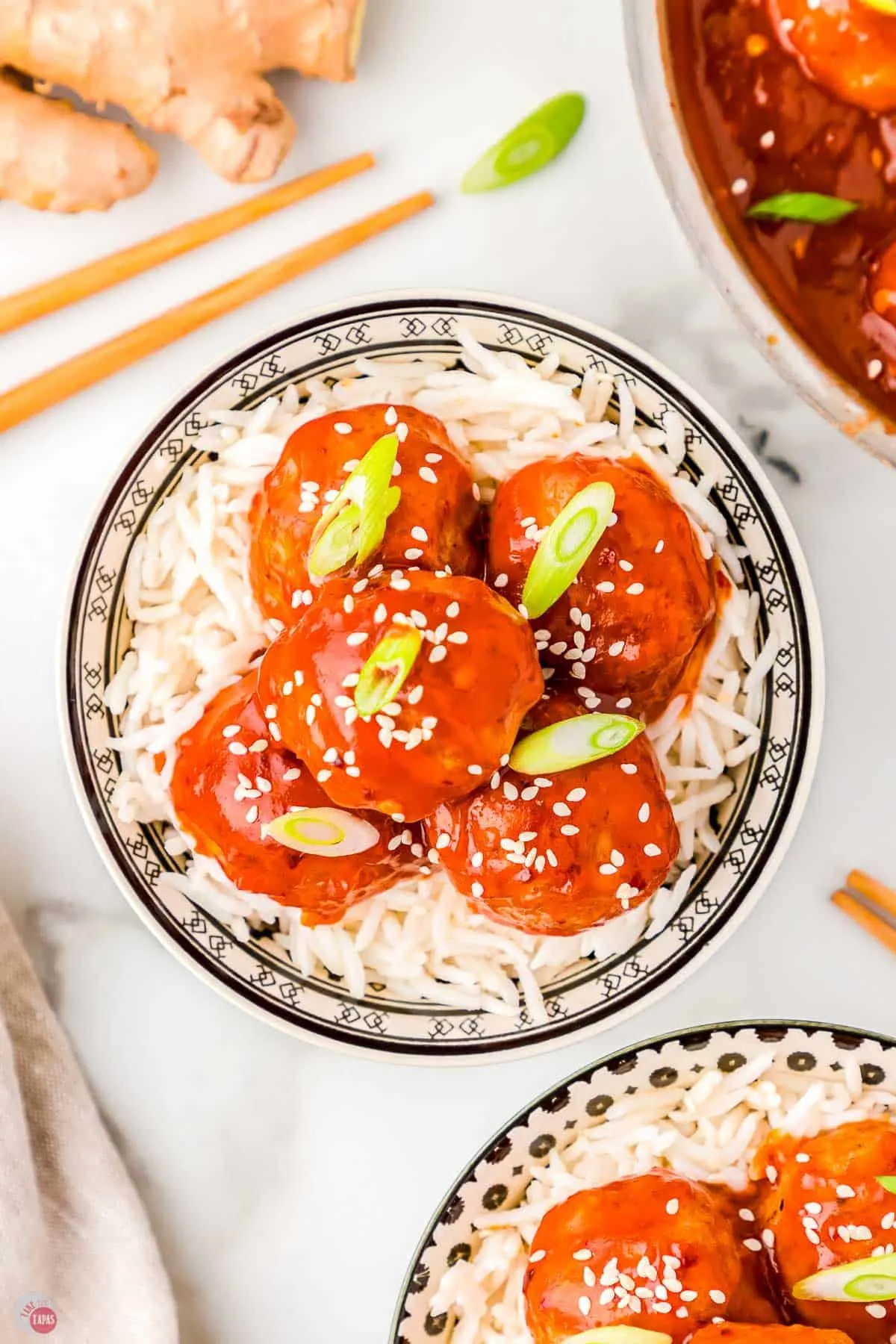 bowl of firecracker meatball recipe over rice with chopsticks