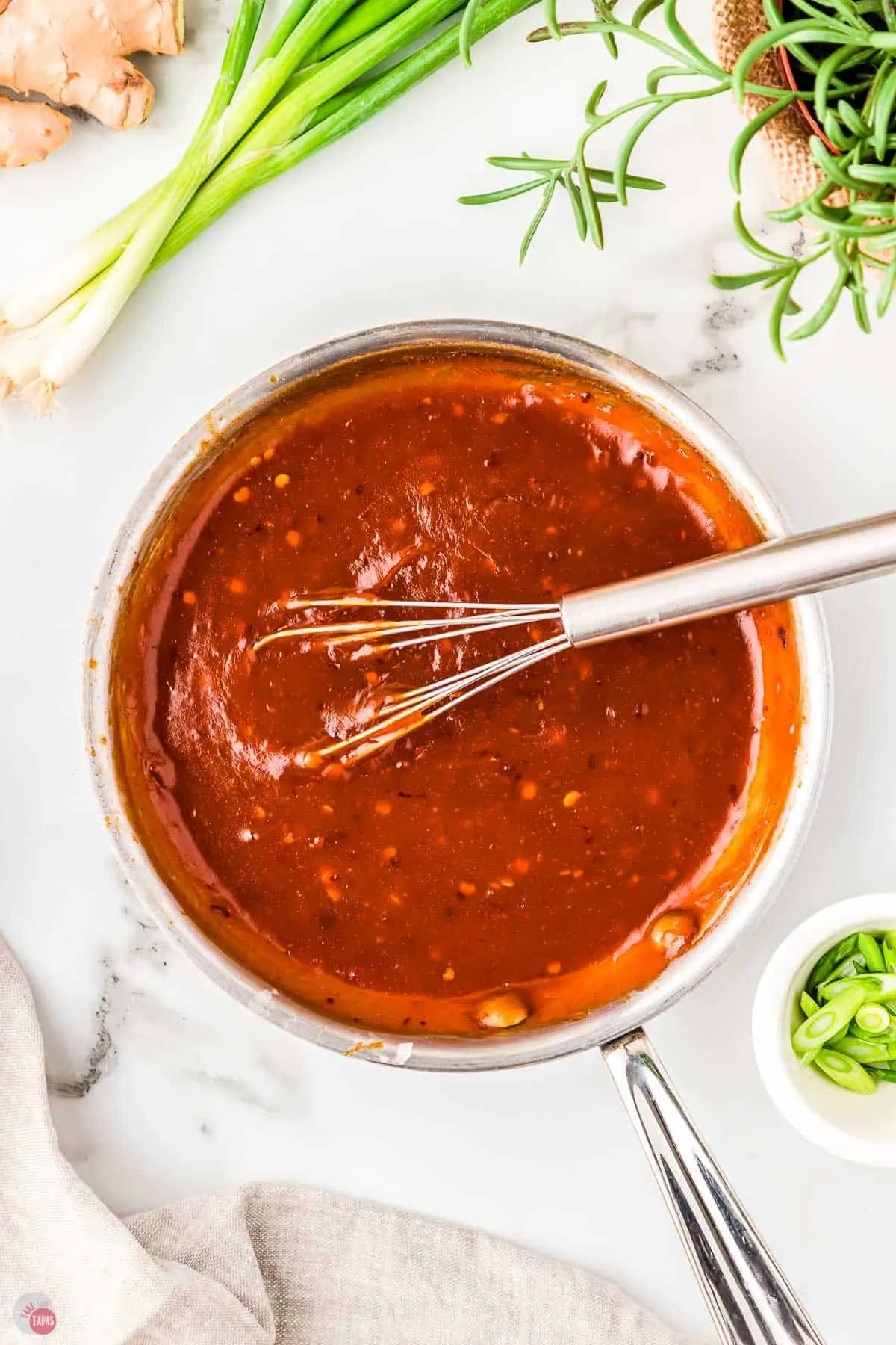 firecracker sauce in a pan with a metal whisk