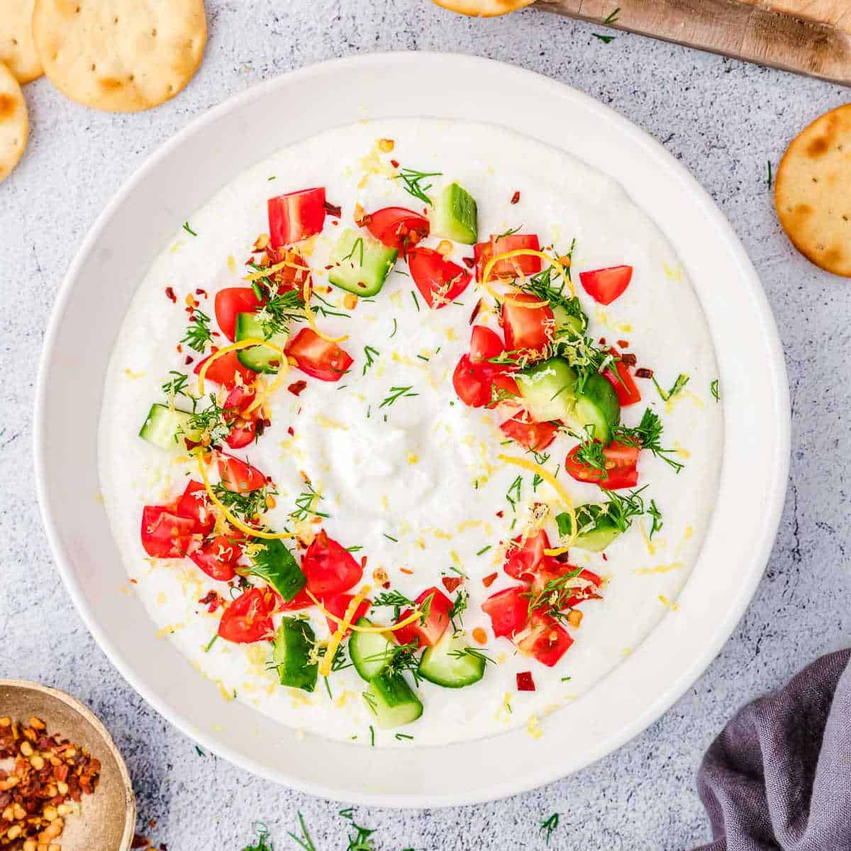 bowl of greek feta dip topped with lemon and dill