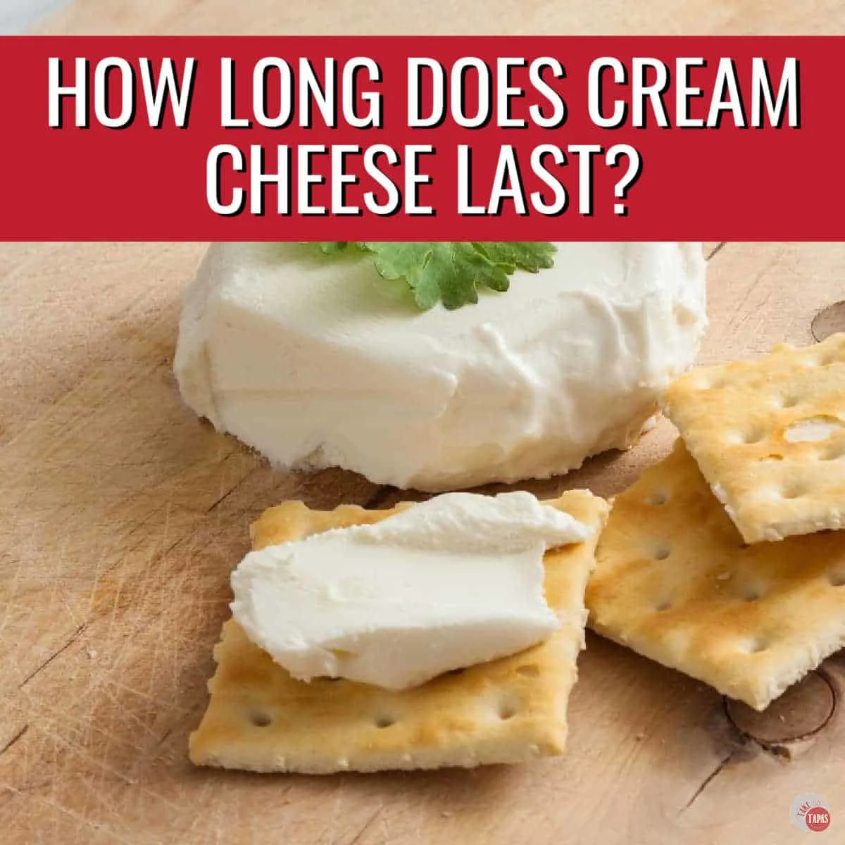 crackers with cream cheese and a red banner with white text
