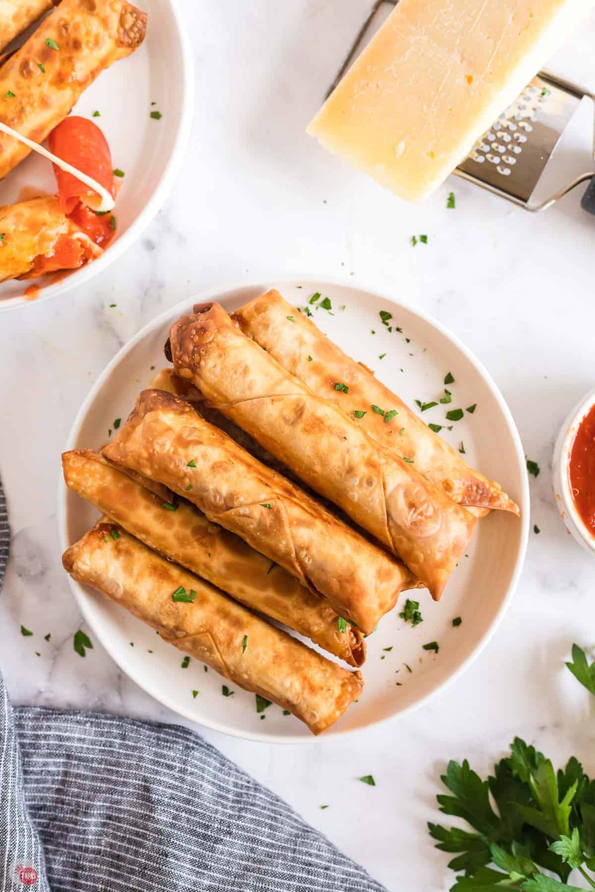 overhead picture of pizza egg rolls on a plate