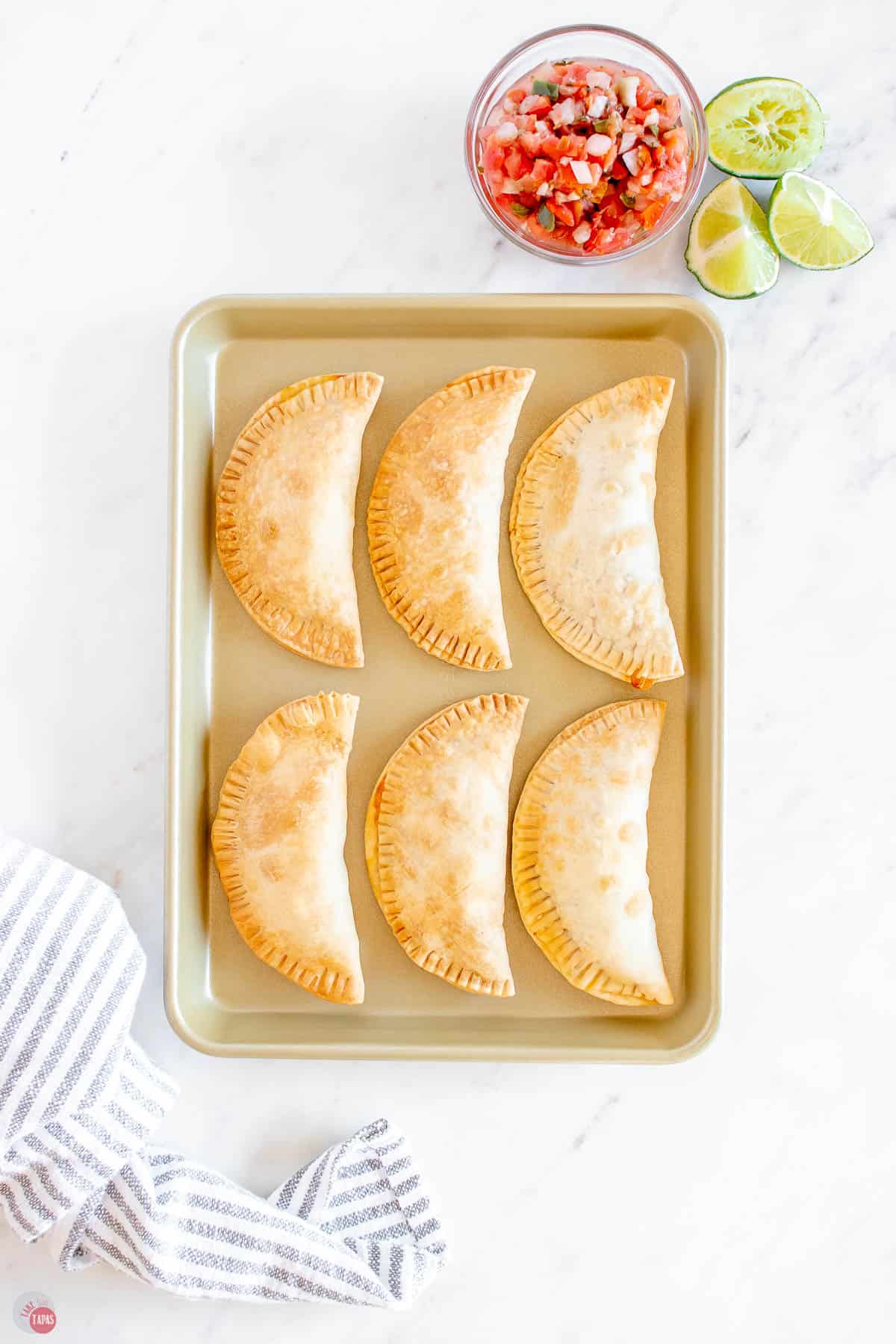 empanadas on a baking sheet