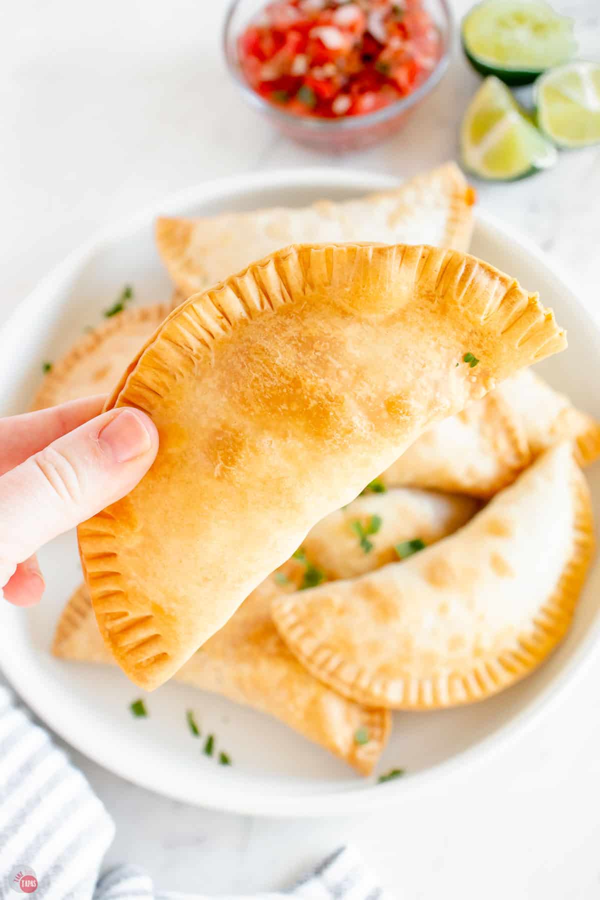 hand holding an empanada