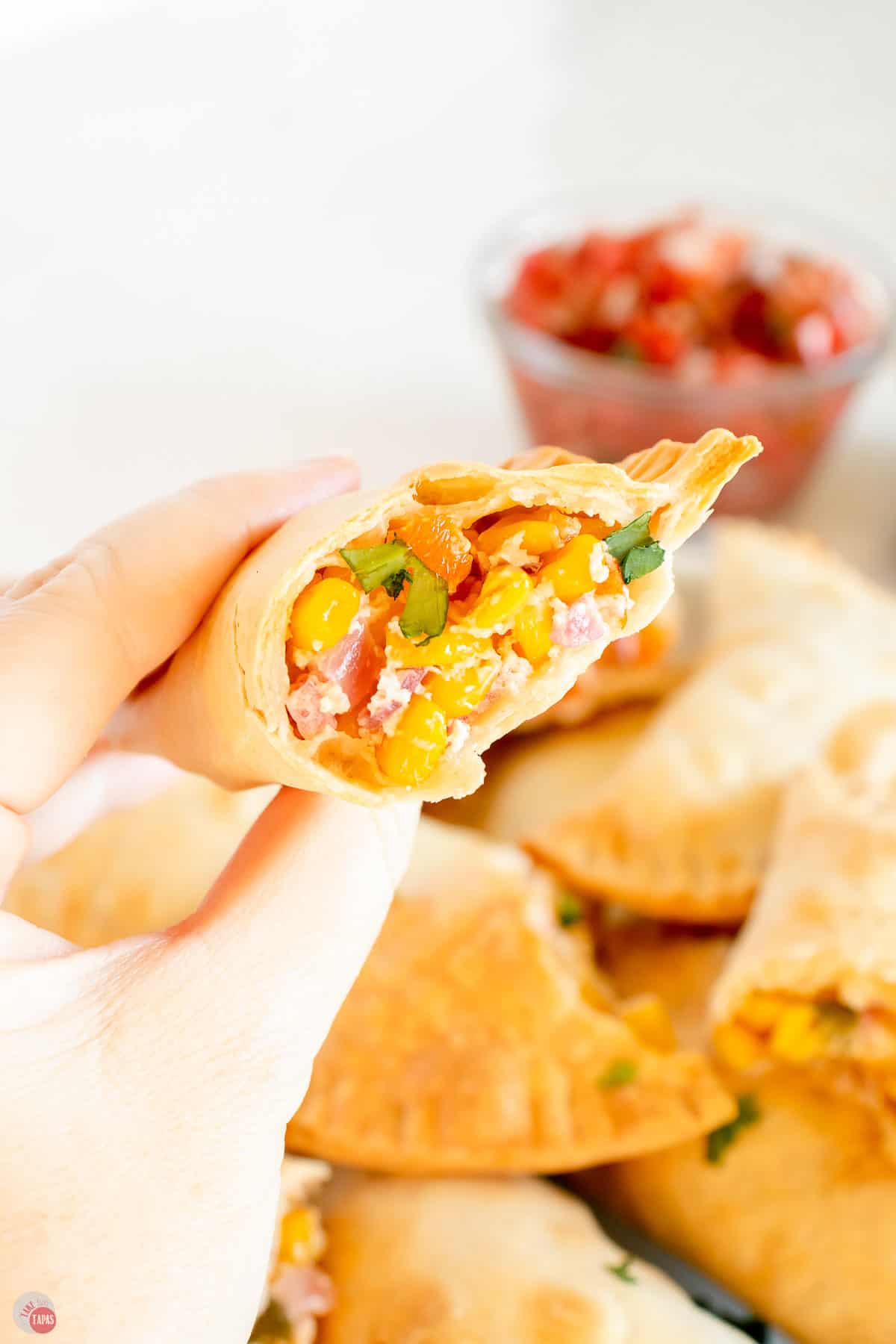 empanada cut open and held in a hand