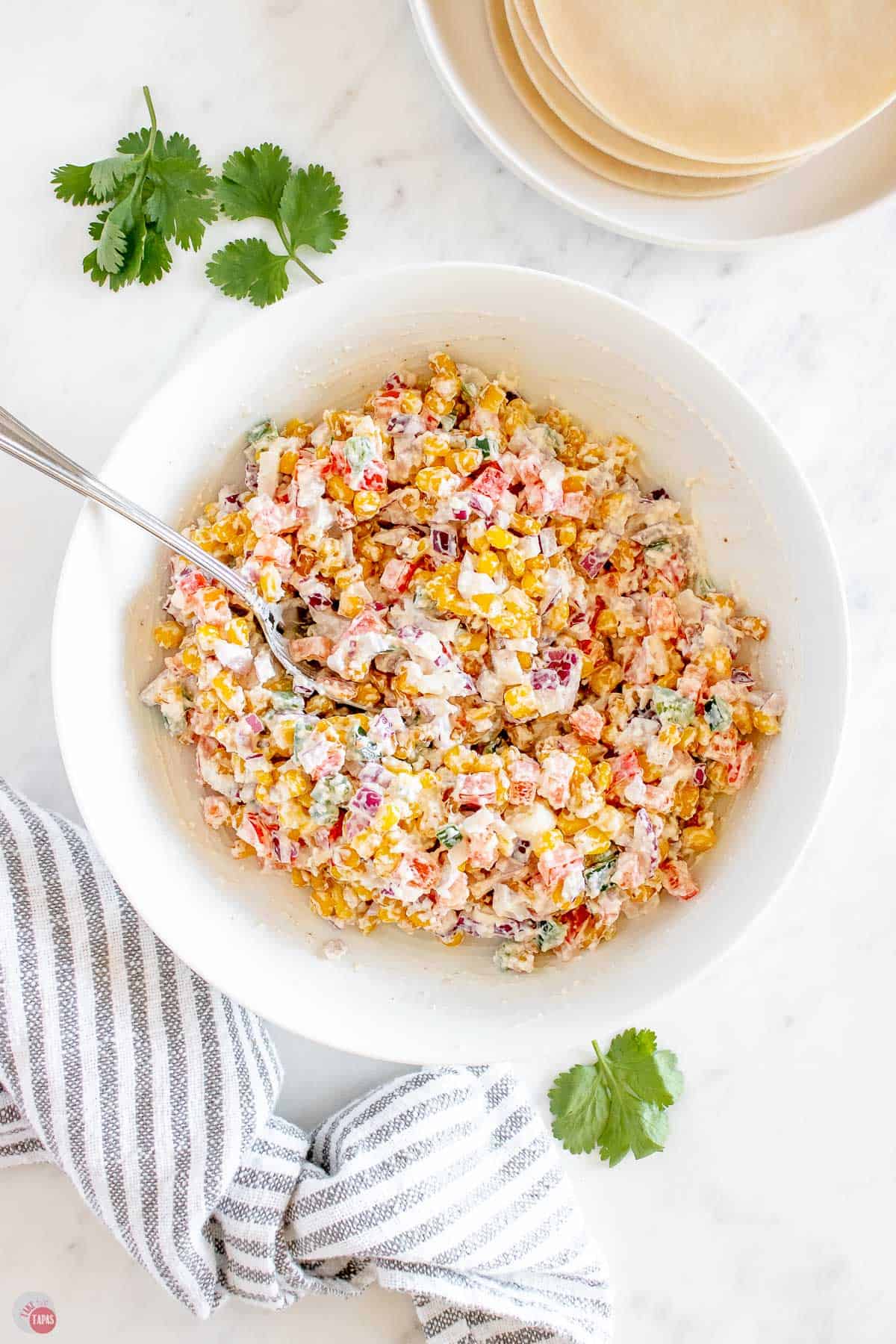 corn salad in a bowl with a spoon