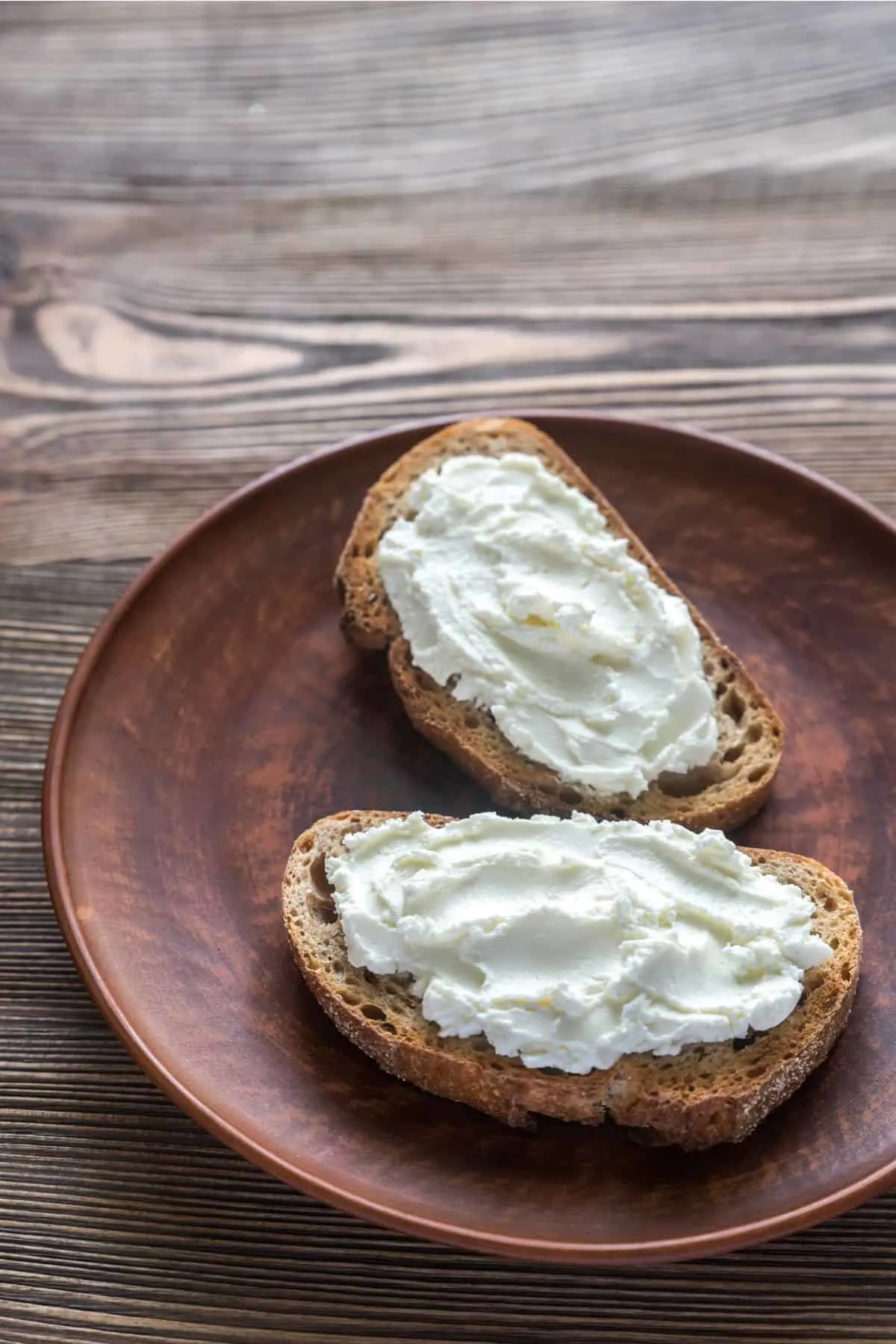 two crostinis with much cream cheese on them