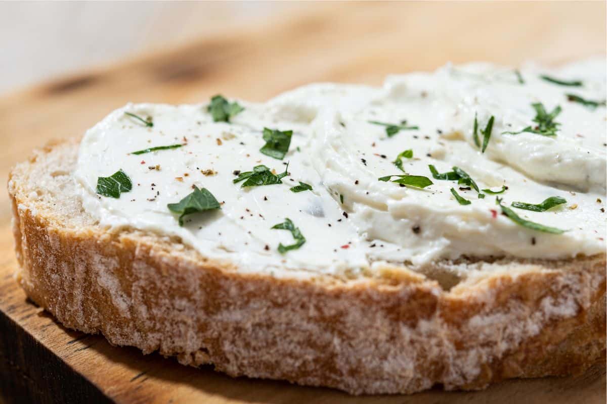 cream cheese smeared on bread topped with parsley